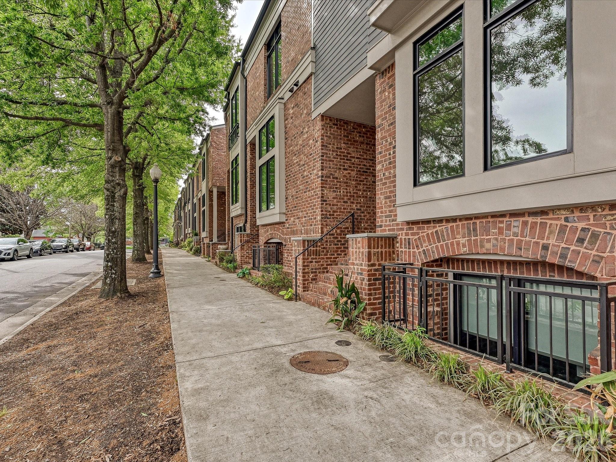 Welcome to Highland Park — a brick brownstone townhome in the heart of NoDa. Recently built, this 4-bedroom, 4.5-bath home delivers a sleek, modern interior that feels like it belongs in a design magazine. The main living area features a chef's kitchen anchored by an oversized quartz island, custom cabinetry with soft-close hardware, and bold black stainless appliance suite with gas range,

Truly move-in ready with hardwood floors, modern black casement windows, designer tile in every bath, and metal railings throughout. The home has a flexible layout with all bedrooms having en-suite bathrooms attached.

Off the main living you'll find a private balcony with westerly exposure. The rear access garage has epoxy floors and plenty of storage rounding out the unit.
