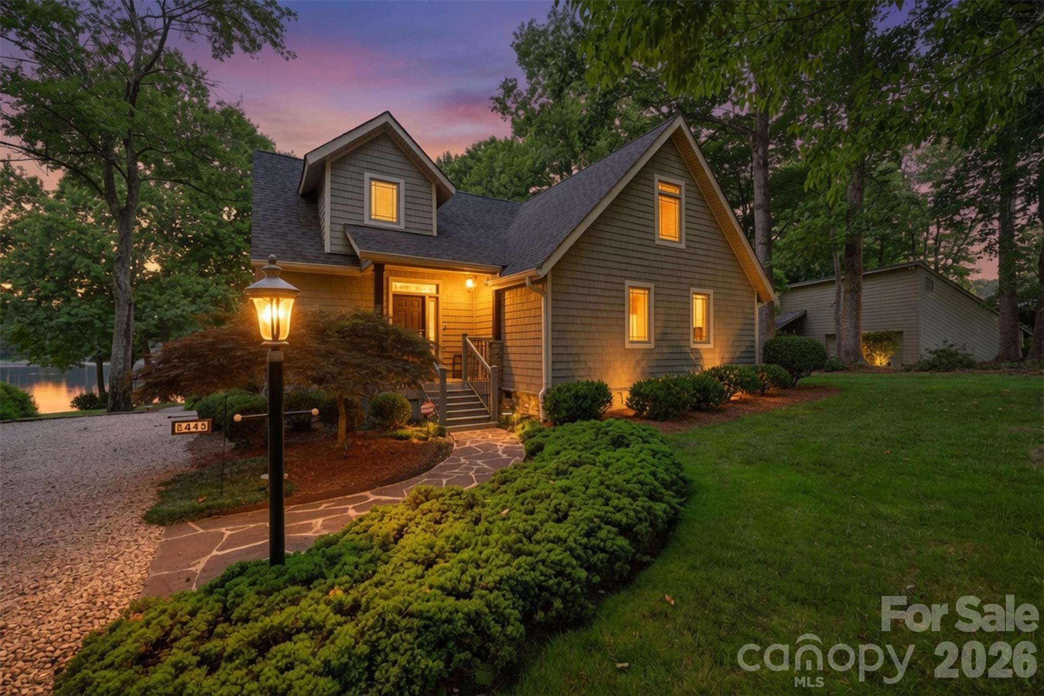 Welcome to your own slice of Lake Norman paradise! Perfectly situated on .625 acres with picturesque waterfront views, this beautifully maintained home offers the ideal blend of comfort, elegance, and lakeside living.

Step inside to discover a stunning great room with soaring vaulted ceilings, gleaming floors, and a dramatic wall of windows that fills the home with natural light while showcasing the peaceful surroundings. The open-concept design creates an inviting space for entertaining or simply relaxing after a day on the water.

The beautifully updated kitchen is a dream, featuring custom cabinetry, granite countertops, stainless steel appliances, a spacious center island, abundant storage, and a built-in desk are; perfect for preparing meals while staying connected to family and guests.

A spacious loft overlooks the great room below, offering endless possibilities as a home office, reading nook, or additional living space. Thoughtfully designed with three full bathrooms, this home provides comfort and privacy for family and visitors alike.

Outside, mature landscaping, a charming stone walkway, and lush greenery create exceptional curb appeal, while the waterfront setting invites you to enjoy boating, fishing, kayaking, or simply taking in the tranquil lake views.

Whether you're searching for a full-time residence or the perfect weekend retreat, 8445 Timberlake Lane offers the rare opportunity to enjoy the best of Lake Norman living in a peaceful, established setting.
