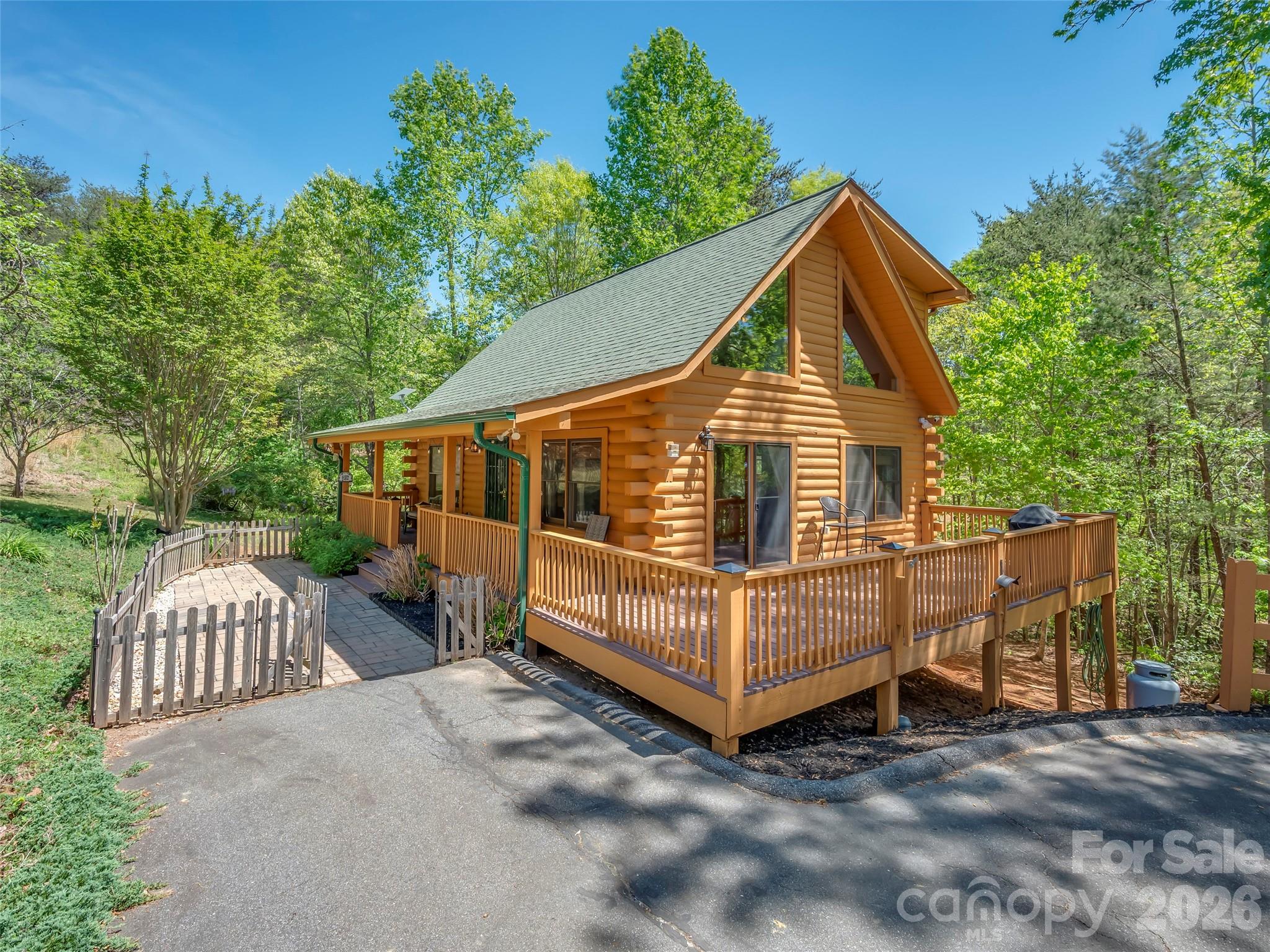Tucked away in the gated community of South Mountain Peaks, this charming 2BR/2BA log cabin offers the perfect blend of mountain serenity and everyday comfort. Situated on approximately 0.69 acres, this well maintained retreat features warm wood interiors, a cozy gas log fireplace, and an inviting layout for relaxation and entertaining. Enjoy quiet mornings and evenings from the rocking chair front porch, surrounded by natural beauty, with a gentle stream adding to the tranquil setting. This home is being sold fully furnished, making it turnkey and ready for immediate enjoyment—whether as a full-time residence, weekend getaway, or potential income-producing rental. Thoughtfully cared for, the exterior has been freshly painted, enhancing curb appeal and value. Additional features include paved access, a utility building for extra storage, and a private setting within a gated community. Conveniently located within driving distance to Forest City, Rutherfordton, and outdoor recreation like Jellystone Park, this property offers a great balance of privacy and accessibility. Nearly everything conveys.