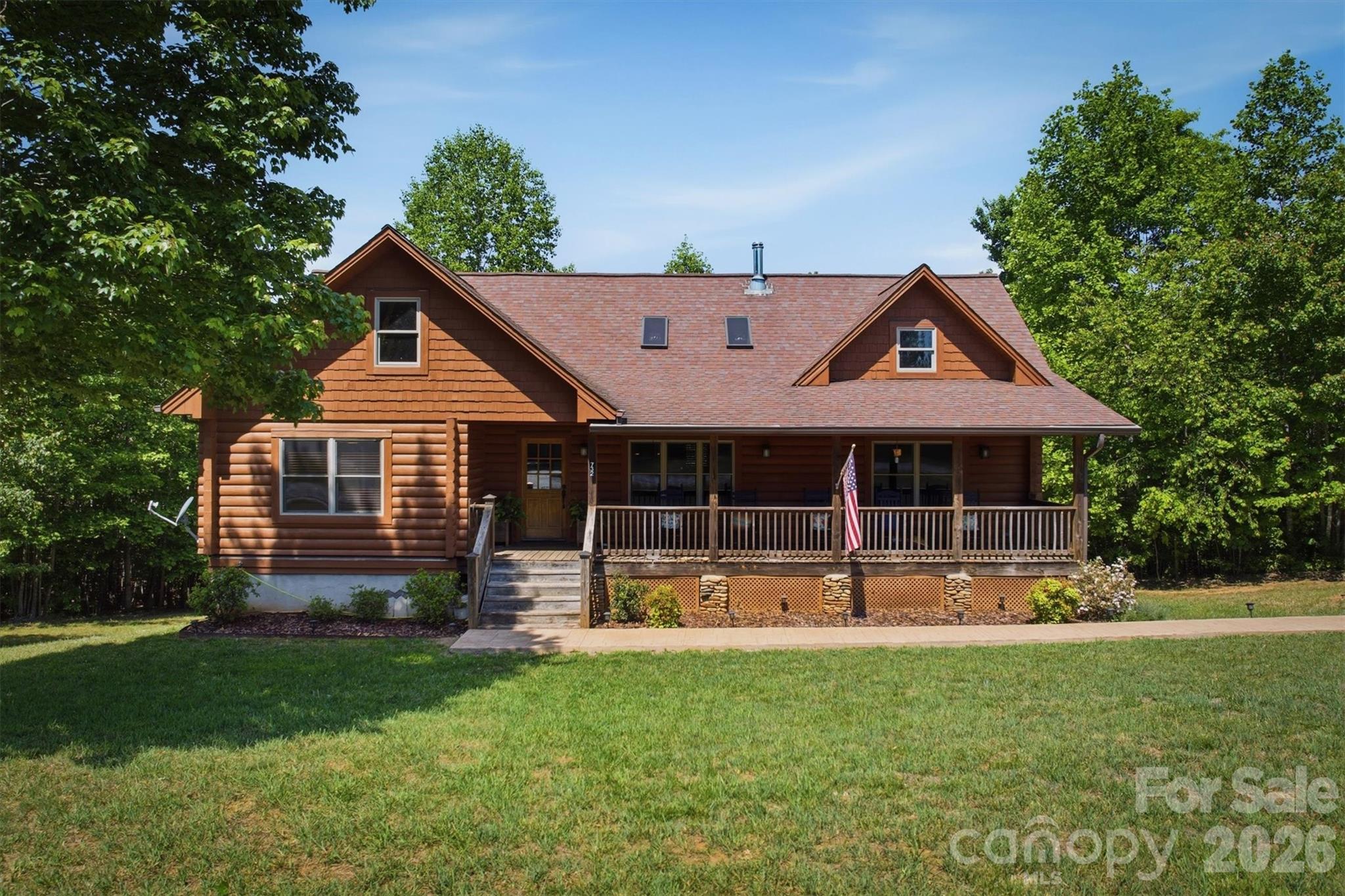 Welcome to 732 Grandview Peaks Drive in Nebo, North Carolina, where mountain mornings arrive quietly through the trees and evenings are best spent on the porch listening to the sounds of nature. Tucked inside the gated community of Grandview Peaks and surrounded by 2.17 wooded acres, this mountain retreat offers privacy, comfort, and the peaceful setting buyers hope to find in Western North Carolina.

The drive through Grandview Peaks immediately sets the tone with winding paved roads, scenic mountain views, and a sense of stepping away from the noise of everyday life. Positioned beautifully among the hardwoods, the home welcomes you with a covered front porch that feels made for rocking chairs, coffee at sunrise, and long conversations after sunset.

Inside, warm wood finishes, soaring ceilings, skylights, and abundant natural light create an inviting atmosphere throughout the home. The spacious great room centers around a wood burning stove, adding warmth and character during cool mountain evenings and cozy weekends in every season.

The open layout connects the kitchen, dining, and living areas seamlessly, creating an easy flow for gathering with family and friends. Large windows frame peaceful wooded views and bring the outdoors into the living space. Whether returning from a day on Lake James, hiking nearby trails, or exploring Marion and Morganton, the home feels comfortable, relaxed, and connected to its surroundings.

The main level includes three bedrooms and two full bathrooms, offering practical one level living with room for guests and family alike. Downstairs, the full unfinished basement provides outstanding flexibility for future expansion, recreation space, workshop space, or additional storage. With generous square footage already in place and walk out access, future owners have endless possibilities to customize the lower level to fit their needs.

Outdoor living is equally appealing. The rear porch overlooks the wooded property and creates a private setting for entertaining, relaxing, or simply enjoying the fresh mountain air. Mature trees surround the home while usable outdoor space offers flexibility and privacy rarely found together.Grandview Peaks is known for its gated entrance, scenic setting, walking trails, picnic areas, community lake access, paved roads, and underground utilities. Conveniently located near Lake James, Marion, and Morganton, the community offers easy access to boating, hiking, fishing, wineries, breweries, and some of the best outdoor recreation Western North Carolina has to offer. The area is also rich in North Carolina gold mining history, with nearby attractions and historic mining regions adding another layer of adventure and character to the foothills experience.

Whether you are searching for a full time residence, mountain getaway, or vacation rental opportunity, 732 Grandview Peaks Drive delivers the mountain lifestyle buyers dream about when looking for property in the Blue Ridge foothills.