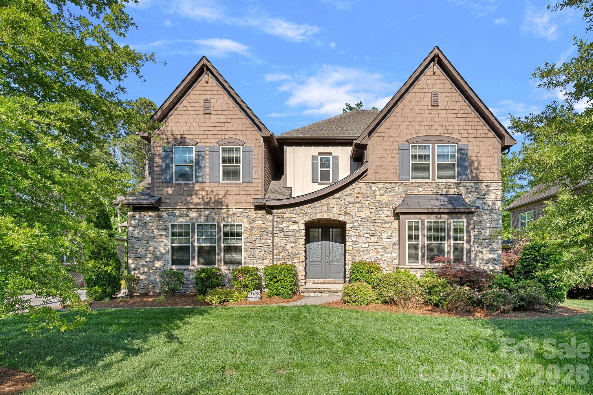 Located in the prestigious The Falls at Weddington community, this stunning property offers luxury living with elegant European-inspired architecture and upscale finishes throughout. This expansive custom-style residence features over 7,000 square feet of living space with 6 bedrooms, 5.5 bathrooms, and a thoughtfully designed open floor plan ideal for both entertaining and everyday living. The home showcases a gourmet kitchen with a large granite island, premium appliances, custom cabinetry, and seamless flow into spacious gathering areas highlighted by soaring 10-foot ceilings and abundant natural light. The main level includes both a luxurious primary suite and a private guest suite, while the upper level offers additional bedrooms, bonus rooms, and flexible living space. Thoughtfully finished basement includes media room, bedroom, bathroom, workout room, flex space and storage room. The basement also includes a large unfinished space, ideal for golf simulators, play room, man cave, storage, or anything you can imagine. Exterior features include elegant brick and stone detailing, a three car garage, professionally maintained landscaping, and a wooded homesite that enhances privacy and curb appeal. Residents of The Falls at Weddington enjoy resort-style amenities including walking trails, a clubhouse, fitness center, pool, ponds, and sidewalks, all within the highly sought after Weddington school district. Conveniently located near I-485, shopping, and dining, this property blends luxury, comfort, and convenience in one of Union County's most desirable neighborhoods.