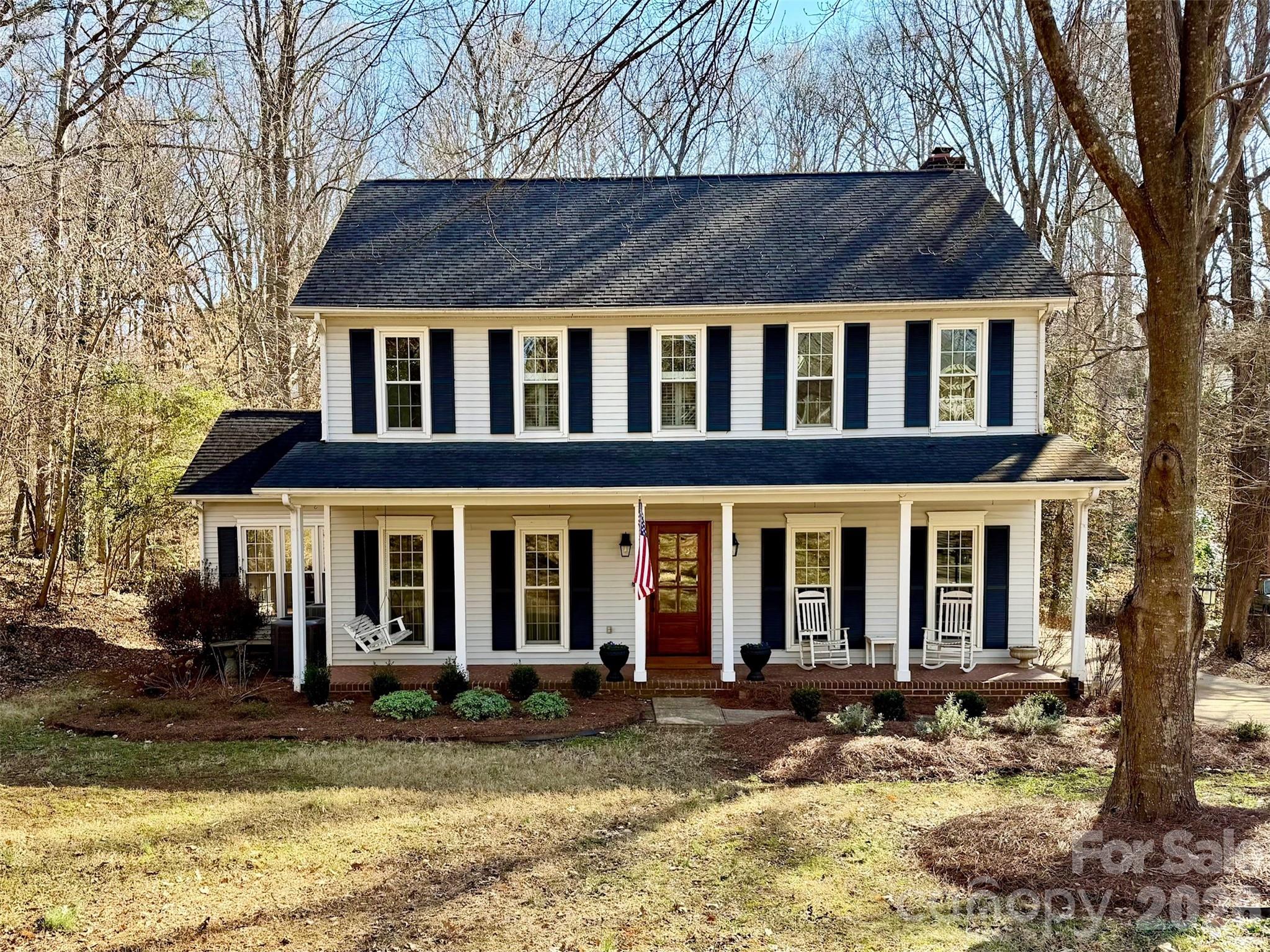 This beautifully updated 4-bedroom home in the highly desirable Old Orchard neighborhood of Fort Mill sits on an expansive .68-acre wooded lot with extensive privacy, a spacious deck, and an inviting front porch complete with rocking chairs and a charming swing. Inside, you’ll find hardwood floors throughout the main level and all bedrooms, fresh interior paint and fixtures. Thoughtfully designed living spaces including a formal sitting room and flexible front room ideal for a home office. The renovated kitchen is a true highlight, featuring updated appliances, a generous eat-in area, two pantries, and an open layout to the family room—perfect for everyday living and entertaining. Upstairs, the primary suite offers a tray ceiling, and a walk-in closet, while three additional bedrooms also feature hardwood flooring. The spacious bonus room includes built-ins, new carpet, walk-in attic access, and a closet, making it an ideal fifth bedroom or multi-purpose space. Additional custom built-ins in the downstairs sitting room and a beautifully designed drop zone add both character and function. With fully updated flooring, a new HVAC system, and a large private lot, this move-in-ready home offers comfort, style, and exceptional space both inside and out. Way too much to list easy to show set your appointment now.