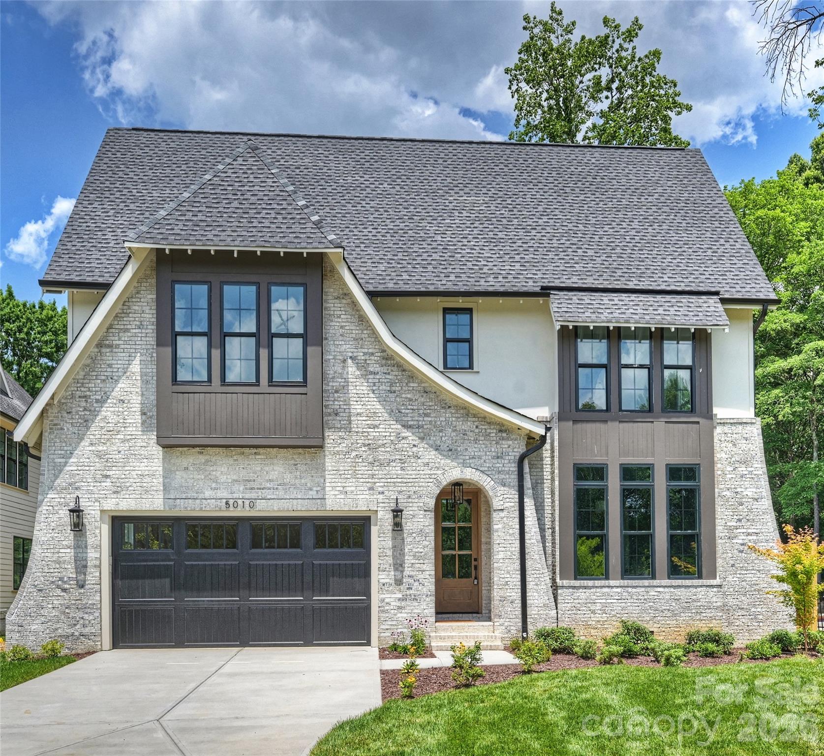 Built by Epic Homes and featuring custom architecture by Frusterio Design alongside beautiful selections by Crystal Nagel Design, this spectacular home radiates sophistication and elegance. The layout welcomes you with bright open spaces, perfect for effortless entertaining and thoughtful design for everyday living. Imagine cooking in the chef's kitchen, equipped with professional appliances and plenty of cabinet space! The open concept flows seamlessly into the dining area and inviting living room, highlighted by a stunning fireplace and surround. Large sliding doors open up to the covered porch, ideal for relaxing outside. The main level primary bedroom is a serene retreat, showcasing a custom-designed closet and a spacious bathroom complete with a luxurious tub and oversized shower. The second floor features three additional bedrooms, two baths, and a delightful game room, making it perfect for family or guests. Ideally situated in South Charlotte.