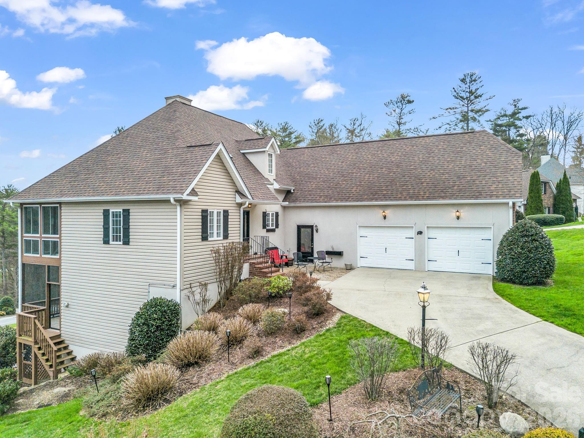 Set on a corner lot within the gated Carriage Park community, this 3BR/3.5BA home offers a thoughtful layout with main-level living and a basement level. An open floor plan anchors the main level. Prefinished wood floors carry through a spacious living area with gas log fireplace into a well-appointed kitchen featuring Fusion Quartzite counter tops, breakfast bar, stainless appliances, and generous cabinetry, all flowing seamlessly to the dining area. The primary suite on the main level provides a comfortable retreat with dual vanities, garden tub, separate shower, and walk-in closet, while additional bedrooms and flexible space on the lower level create options for guests, office, or recreation. A glass-enclosed and screened rear porch extends the living space and captures long-range views, complemented by a private front patio space and multiple outdoor sitting areas. Refrigerator, washer/dryer to convey. Recent updates include a new roof (2024), and updated HVAC systems, adding peace of mind. Storage is abundant with unfinished lower-level areas and a 2-car garage. The sloped lot enhances both privacy and perspective. Community amenities include clubhouse, indoor pool, tennis/pickleball courts, library, walking trails around the pond, and social activities, creating a well-rounded lifestyle setting.
