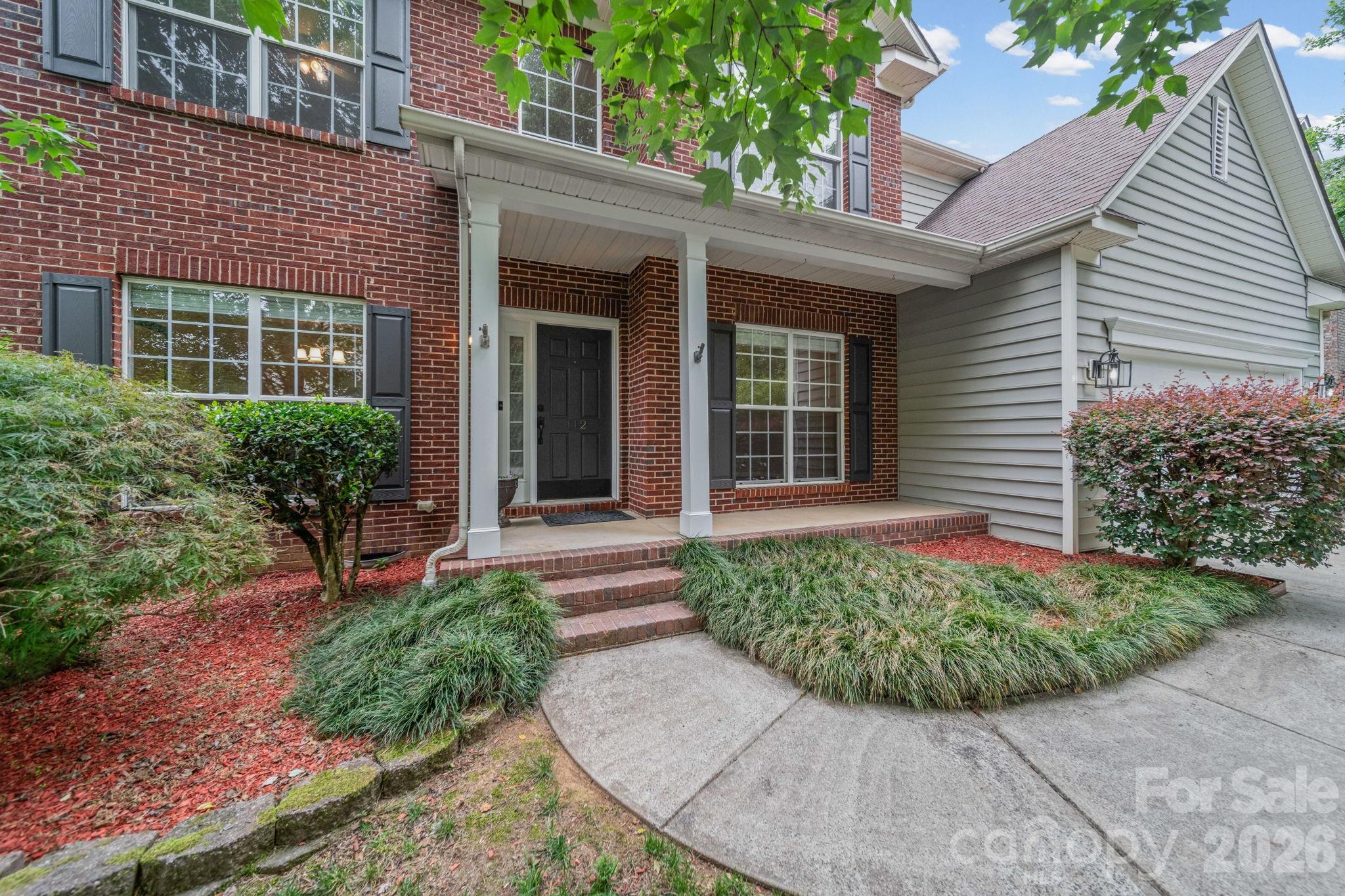 Welcome home to this stunning Hunter Oaks retreat featuring a dramatic two-story great room with soaring vaulted ceilings, clerestory windows, and a gas log fireplace — the heart of a thoughtfully designed open floor plan. Cared for by its original owners since 2002, this home shines with pride of ownership throughout. The main-level primary suite offers a private en suite with jetted soaking tub, renovated walk-in shower with glass door (not pictured), and spacious walk-in closet. Fresh updates throughout include new LVP flooring on the main level, new carpet on stairs and upper level, all new interior paint, and new GE stainless range and microwave. A formal dining room with tray ceiling and wainscoting, a French door office/flex room, and a 5th bedroom currently configured as a dedicated home theatre with ceiling-mounted projector, 120" screen, and Polk Audio 5.1 surround sound complete this exceptional home. Refrigerator, GE washer/dryer, and all theatre equipment convey. Freshly painted deck overlooks a private wooded and fully fenced backyard.  Zoned for A+ Marvin Ridge schools. Ideally located approximately 5 minutes to Blakeney Shopping Center, 7 minutes to Waverly, 15 minutes to Ballantyne, 30 minutes to Uptown Charlotte and Charlotte Douglas International Airport, and just 10 minutes to charming Downtown Waxhaw. Hunter Oaks amenities include two pool complexes, tennis courts, playground, and walking trails, all supported by an active HOA community. Schedule a tour today!