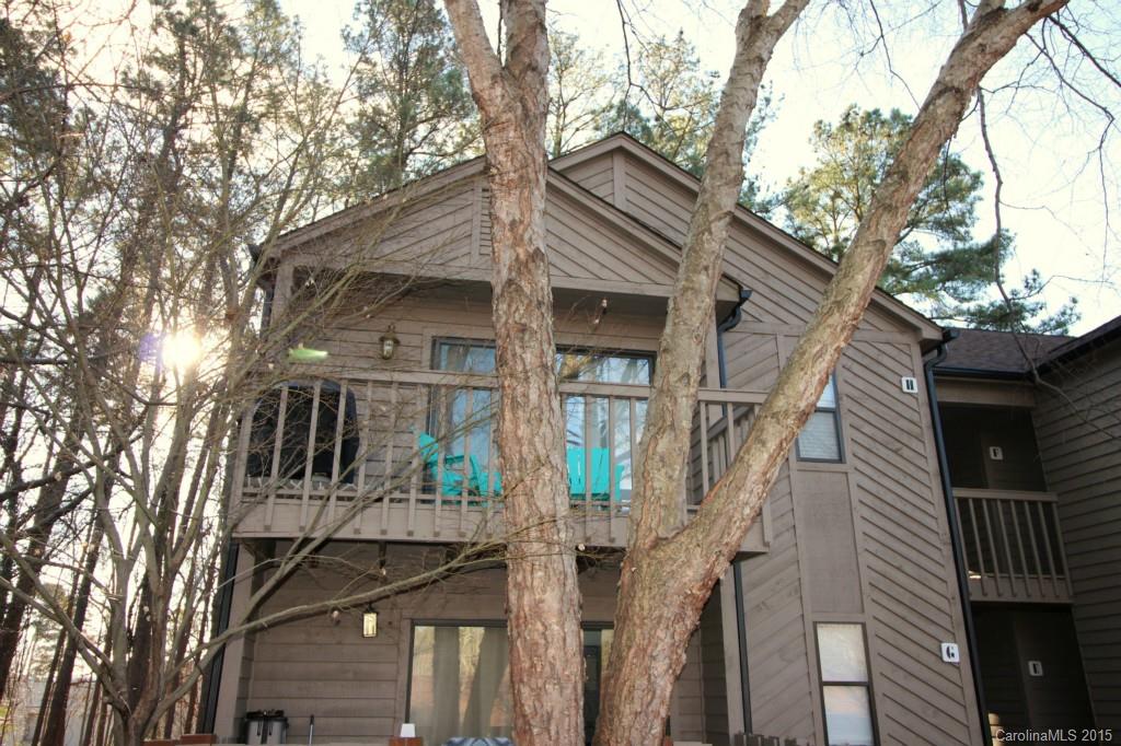 Welcome to Lake Wylie Woods, nestled among the trees on 15 acres of Lake Wylie waterfront property with a community dock and pool in the Clover School District. This end unit is updated with granite counters and tile back-splash in the kitchen, endless hardwood floors throughout the open plan, including the bedrooms, & tile floors in the kitchen and baths. Enjoy your mornings on 1 of 2 balconies.