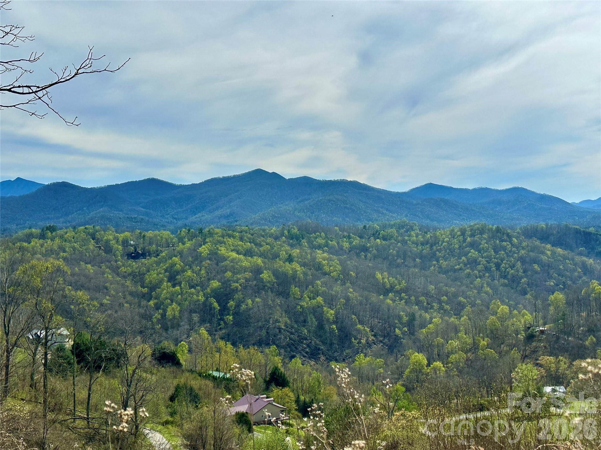 If Views Are Your Desire… This Lot Is Waiting for You!
Imagine waking up every morning to breathtaking, wide-open 180-degree mountain views that stretch forever. From the comfort of your future deck, watch the Toe River wind through the valley below while the CSX train meanders through the scenic landscape. Gaze across the iconic Black Mountain Range all the way to the Unaka Mountain Range, with Celo Knob anchoring one side and Big Ball rising prominently on the other.  This is Sunset Mountain — one of the most spectacular view corridors in all of Western North Carolina.
Property Highlights:
*-2.45 acres of prime mountain land at over 3,000 feet elevation
* Year-round unbeatable panoramic views — some of the widest and most dramatic in the region
* Perfect, easy-to-build site with gentle topography
* Community road frontage at both the top and bottom of the lot — ideal for a beautiful circle driveway and effortless access
* Well-maintained POA roads
* Privacy, peace and natural beauty in a scenic mountain community
* Just 5 miles outside the charming, artsy small town of Bakersville, NC — a real down-home community with easy living, friendly folks, no rush-hour traffic and that authentic mountain vibe everyone dreams about.
* Adventures Right at Your Doorstep:
Only 6 minutes to Loafers Glory Rafting and Tubing on the North Toe River
Minutes from the Appalachian Trail, world-class hiking, trout fishing in pristine streams, kayaking, swimming and endless outdoor recreation
* Quick drive to Roan Mountain State Park (famous for its massive, spectacular natural gardens of Catawba rhododendrons that explode in vibrant blooms each summer).  Whether you're building your forever mountain home, a vacation getaway or a smart investment property, this lot is a blank canvas ready for your vision. Bring your dream home plans — the views will do the rest. Sunsets here are legendary. Wide-open, paint-the-sky colors that make every evening feel like a celebration. Don’t wait — properties with views this spectacular and building sites this convenient don’t last long in Western NC.  Views-Views-Views are calling your name.  Ready to make it yours? Contact today to schedule a private showing and see these views in person. Once you stand on this land and take in the panorama, you’ll know — this is the one. Act now — your mountain dream is waiting on Sunset Mountain in Bakersville, NC.