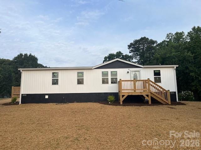 Adorable and completely remodeled home located on 2 acres in the country. This 3-bedroom 2 bath doublewide mobile home features a complete makeover. Interior offers new tongue and groove ceilings, vinyl plank flooring, appliances including refrigerator, range, microwave & dishwasher and alarm system: pretty much everything! Exterior has new roof, siding, windows and decks. Home features a split bedroom plan with a huge open living room with electric fireplace that flows into the kitchen. Nice level yard for pets or to expand upon. Close to the lake and boat ramp for those lake lovers. Short drive to grocery store, shopping, dentist, etc. Easy commute to Lake Hickory, Taylorsville, Bethlehem, Sand Bar Grill and Crossroads Grill. Come take a look at this quality remodeled home today!