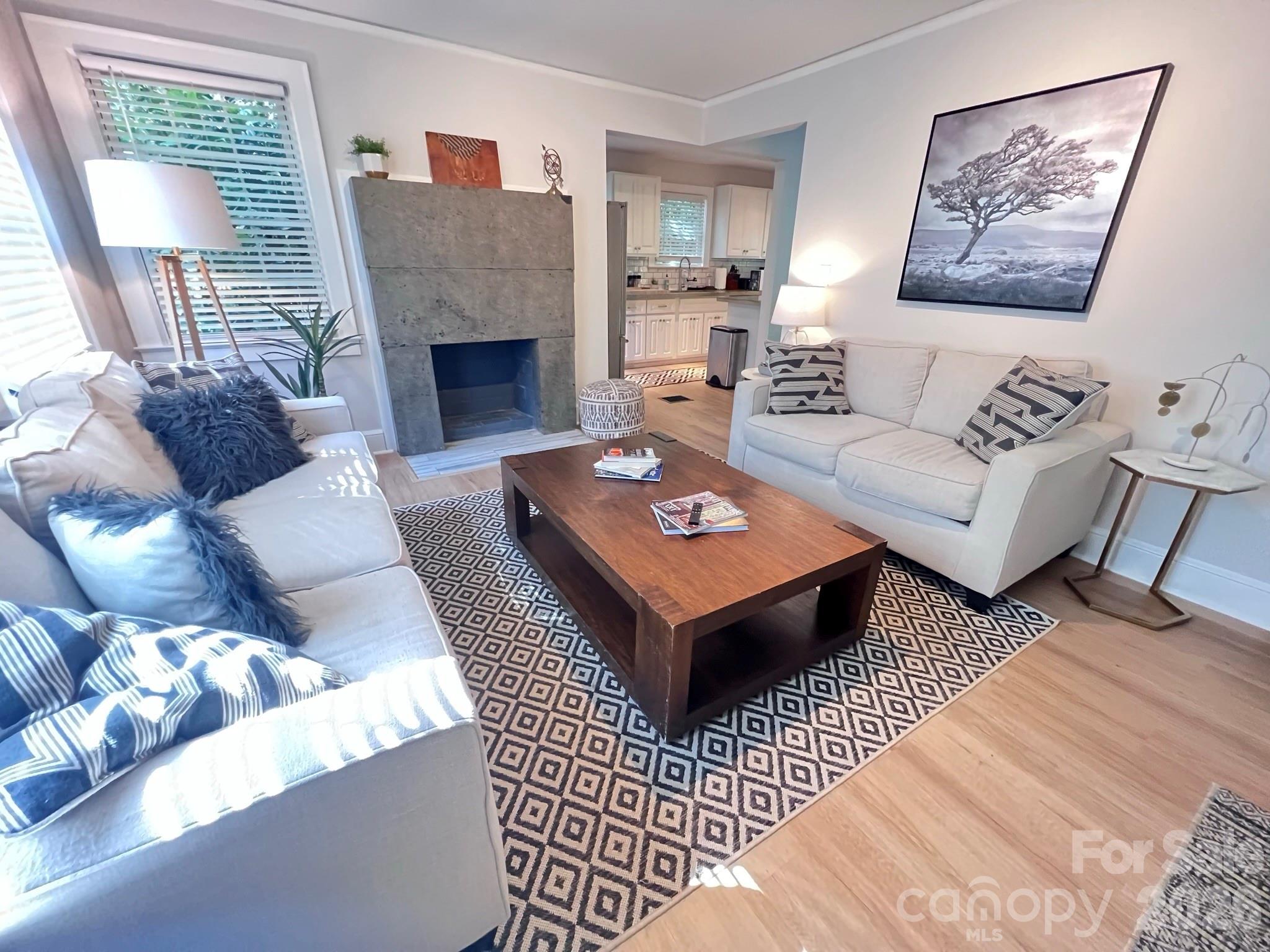 Don't miss this exceptional opportunity to own a beautifully updated 4-bedroom, 2-bath home in one of Charlotte's most desirable locations, Collongwood. Offering 1,746 square feet of finished living space, this charming cottage combines character, flexibility, and value in a way that's hard to find at this price point. The thoughtfully designed layout features two bedrooms and a full bath on the main level, a private upper-level attic bedroom, and a fully equipped lower-level suite complete with its own bedroom, full bath, kitchenette, living space, and cozy reading area—ideal for guests, as an in-law suite, or potential rental income. The main floor showcases stylish updates throughout, including an inviting kitchen with peninsula seating, dining area, custom concrete countertops, and a striking concrete fireplace feature. Step outside to an elevated rear deck overlooking a spacious, tree-lined backyard that provides both privacy and a peaceful natural setting. Additional storage and functionality abound with a conditioned storage room in the basement and approximately 503 square feet of unfinished storage space between the attic and storage room, not included in the home's listed square footage. A secondary laundry hookup located in the upstairs bedroom closet offers the flexibility of separate laundry arrangements when utilizing the lower-level suite independently. Conveniently situated just minutes from the LYNX Blue Line, South End, Park Road Shopping Center, and SouthPark, this move-in-ready home delivers location, versatility, and value all in one package.