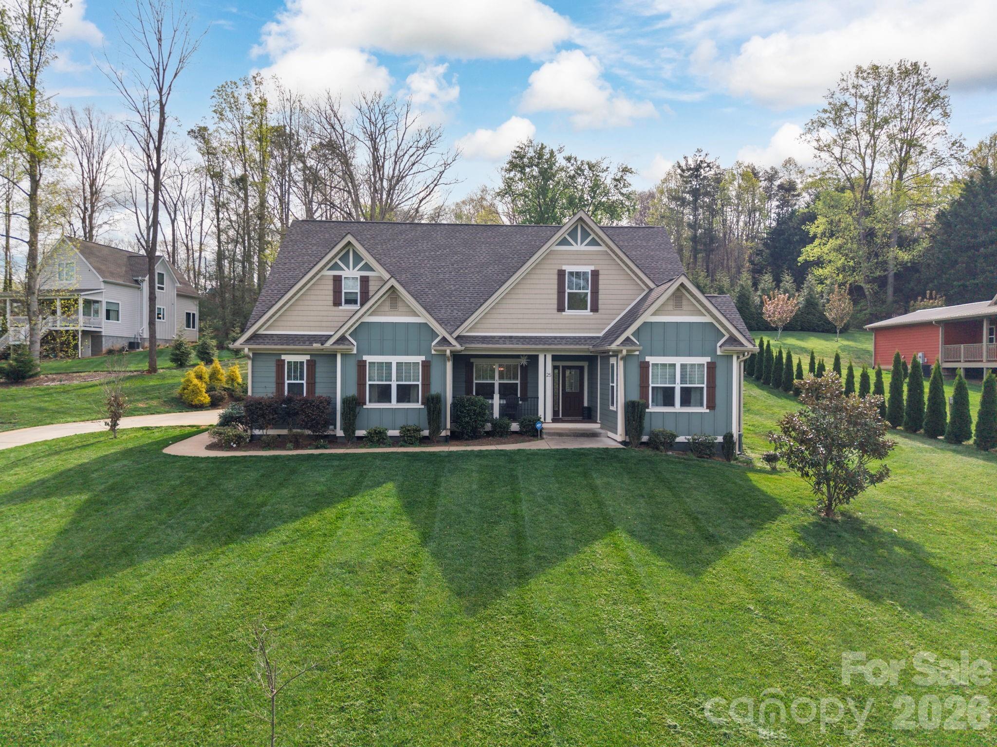 Nestled in a highly desirable South Asheville location, this impeccably maintained home offers the perfect blend of comfort, style, and convenience—just minutes from Biltmore Park, the North Carolina Arboretum, the Blue Ridge Parkway, and the French Broad River. Thoughtfully designed and beautifully appointed, the home sits on a spacious, level lot with winter mountain views and vistas of The Cliffs at Walnut Cove.  Inside, an open-concept floor plan features vaulted ceilings, rich hardwood floors, and a generous dining area ideal for entertaining. The upscale kitchen is equipped with granite countertops, a large island with breakfast bar seating, and a walk-in pantry.  The oversized primary suite serves as a private retreat, complete with a luxurious en-suite bath and walk-in closet. Upstairs, you'll find two bed/bonus rooms, a full bath, and an expansive attic space with excellent potential for future finished square footage.  Outdoor living is equally impressive, with covered front and rear porches overlooking the beautiful property, plus an enormous paved driveway offering abundant parking for family and guests. Multiple flexible-use rooms on both the main and upper levels provide options for home offices, guest accommodations, hobby spaces, or additional sleeping areas. The home is listed as a 3-bedroom property in accordance with the septic permit on file, though its versatile layout offers the functionality of a 4- or even 5-bedroom home.