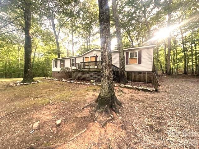 Opportunity awaits on this private 2-acre property in the highly desirable Clover area! Nestled among mature hardwood trees, this home offers a peaceful country setting with plenty of space to spread out while still being conveniently located near Lake Wylie, Downtown Clover, and the Charlotte metro area. A spacious deck overlooks the wooded surroundings, providing the perfect place to relax, entertain, or enjoy the natural beauty and privacy of the property.
Located within the sought-after Clover School District, this property offers easy access to local shopping, dining, parks, recreation, and waterfront activities at nearby Lake Wylie. With approximately 2 acres of land, there is ample room for outdoor living, gardening, recreation, or future improvements.
This property is an excellent opportunity for investors, renovators, or buyers looking to create their dream home in a tranquil setting. Enjoy the best of country living with the convenience of being just minutes from modern amenities, major roadways, and everything the growing Clover and Lake Wylie communities have to offer. A rare chance to own acreage in one of York County's most desirable locations!
