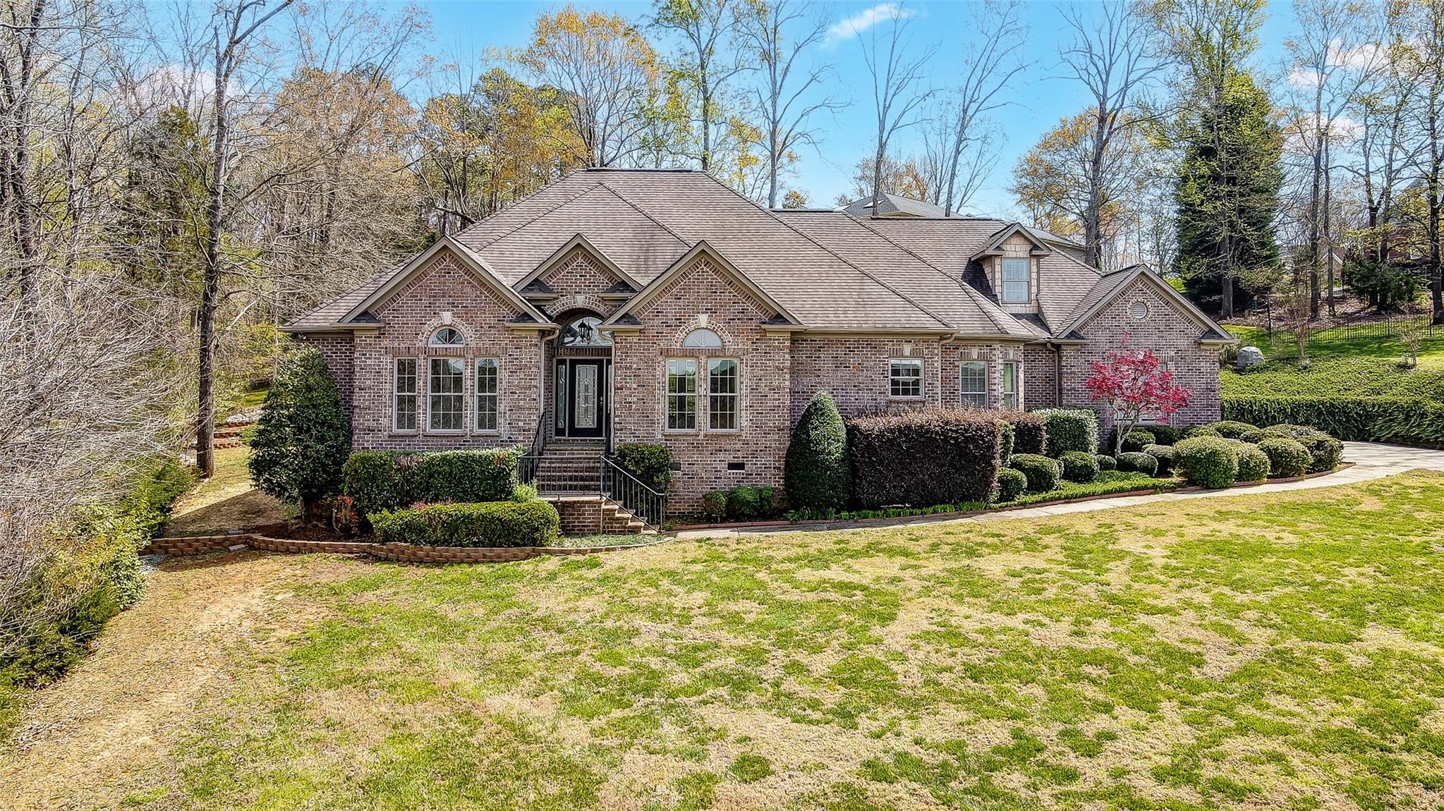 Stunning custom built ranch home with features sure to delight: brick exterior, lake views, open floorplan, rich moldings built-in cabinets, tray ceilings, & gorgeous hardwood flooring. Covered front porch welcomes you into a beautiful light filled foyer, executive office w/ French doors, Formal dining, & fabulous Great room w/ fireplace & built-in cabinetry. Engage your inner chef in the amazing kitchen w/ Stainless Steel appliances, granite counters, breakfast bar, pantry, & dining area. Luxurious primary suite will not disappoint featuring heated tile floors, dual vanities, jetted tub, walk-in shower, & 2 custom walk-in closets. Upper level bonus room can be used as a bedroom for guests or recreation space. Large walk-in attic is great for storage. Covered patio is perfect for outdoor entertaining or just to relax and take in the natural setting. You’ll love beautiful Belmont, with a small-town feel, but oh-so convenient to Uptown Charlotte, shopping, dining, Lake Wylie, & airport.
