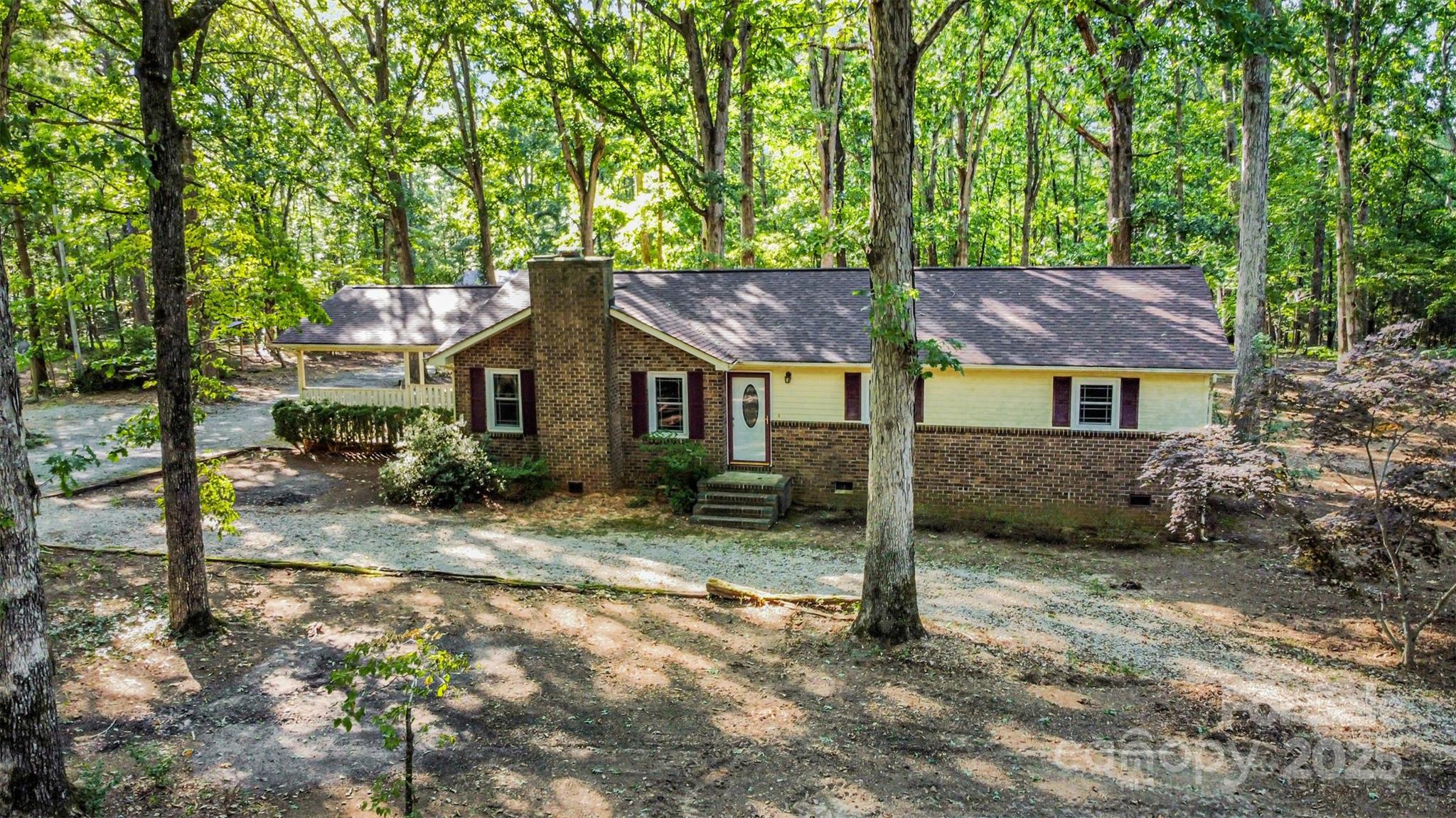 Tucked away on a private 2.71-acre wooded lot with no HOA, this updated 3-bedroom, 2-bath ranch offers privacy, space, and modern upgrades throughout. Inside, you’ll find fresh paint, new flooring, and a fully renovated kitchen featuring new cabinets, granite countertops, and stainless steel appliances. Both bathrooms have been stylishly updated, and new windows bring in natural light to every room. Major improvements include a new roof, HVAC system, and ductwork all completed in 2024, giving the home a refreshed and move-in ready feel. Outside, the property is complete with a 30x31 fabricated steel workshop that is fully heated and cooled, outfitted with upgraded commercial doors, and its own separate electric bill—an excellent setup for hobbies, projects, storage, or business use. Surrounded by trees on a quiet lot, this home combines modern updates with a peaceful setting that’s hard to find!