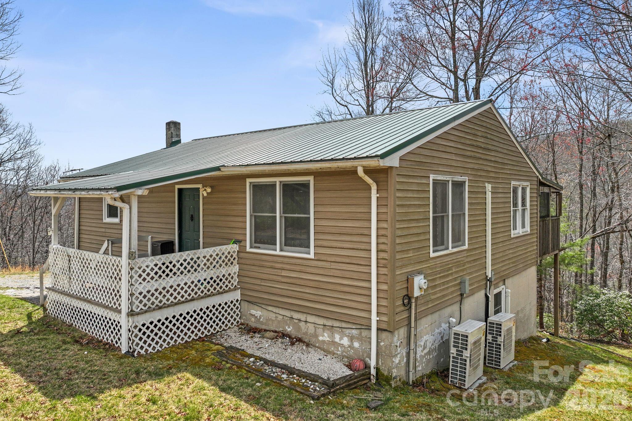 Located within the gated community of Line Runner Ridge, this mountain home sits on 3.82 acres and offers long-range views along with wooded privacy. The home includes two spacious bedrooms and two full bathrooms. The kitchen features an island with seating and a walk-in pantry. The full, partially finished basement provides additional flexibility with a bonus room, wood stove, rock wall, and washer/dryer hookups with a utility sink.
Outdoor living spaces include a covered front porch, screened back porch, and an open back deck. A separate storage building provides space for tools, equipment, or recreational items. Recent updates include a renovated kitchen and bathrooms, bamboo flooring in the kitchen and living room, mini-split heating and air conditioning on both levels, a metal roof, and a new septic tank and drainage system installed in February 2026.
Line Runner Ridge offers a private, 8-acre lake for non-gas boating, fishing, and swimming, adding to the appeal of this mountain setting. Showings by appointment only.