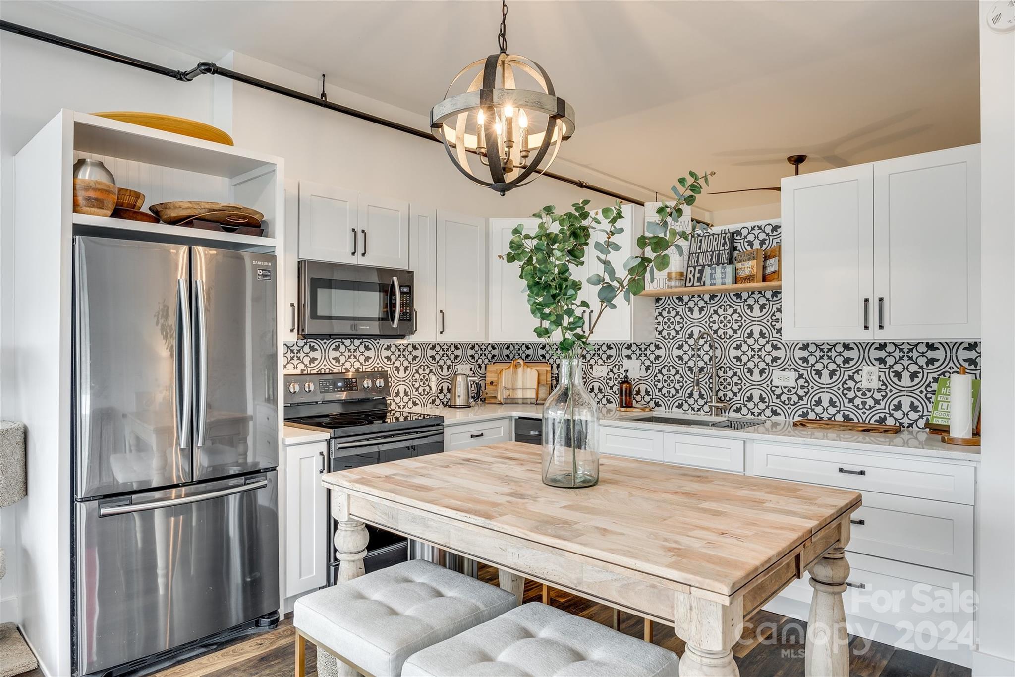 Discover this stunning corner-unit loft with an open floorplan on the top floor of Central 27, situated in the heart of Plaza Midwood. This bright and airy unit offers a unique living experience with 13 foot ceilings and a garage door that opens to a balcony off the kitchen. The balcony is complete with a retractable screen for a seamless indoor/outdoor feel and ideal for entertaining or relaxing. The beautifully designed and updated kitchen features quartz countertops and stainless steel appliances. The unit also includes a custom barn door, custom closet systems, and a tankless water heater. HVAC updated in 2022 and the seller has a service plan for routine touch-ups. Just blocks from the best of Plaza Midwood - groceries, restaurants and nightlife are all within a mile! Don't miss out on this rare opportunity to experience the best of city living in one of Charlotte's most sought after neighborhoods!