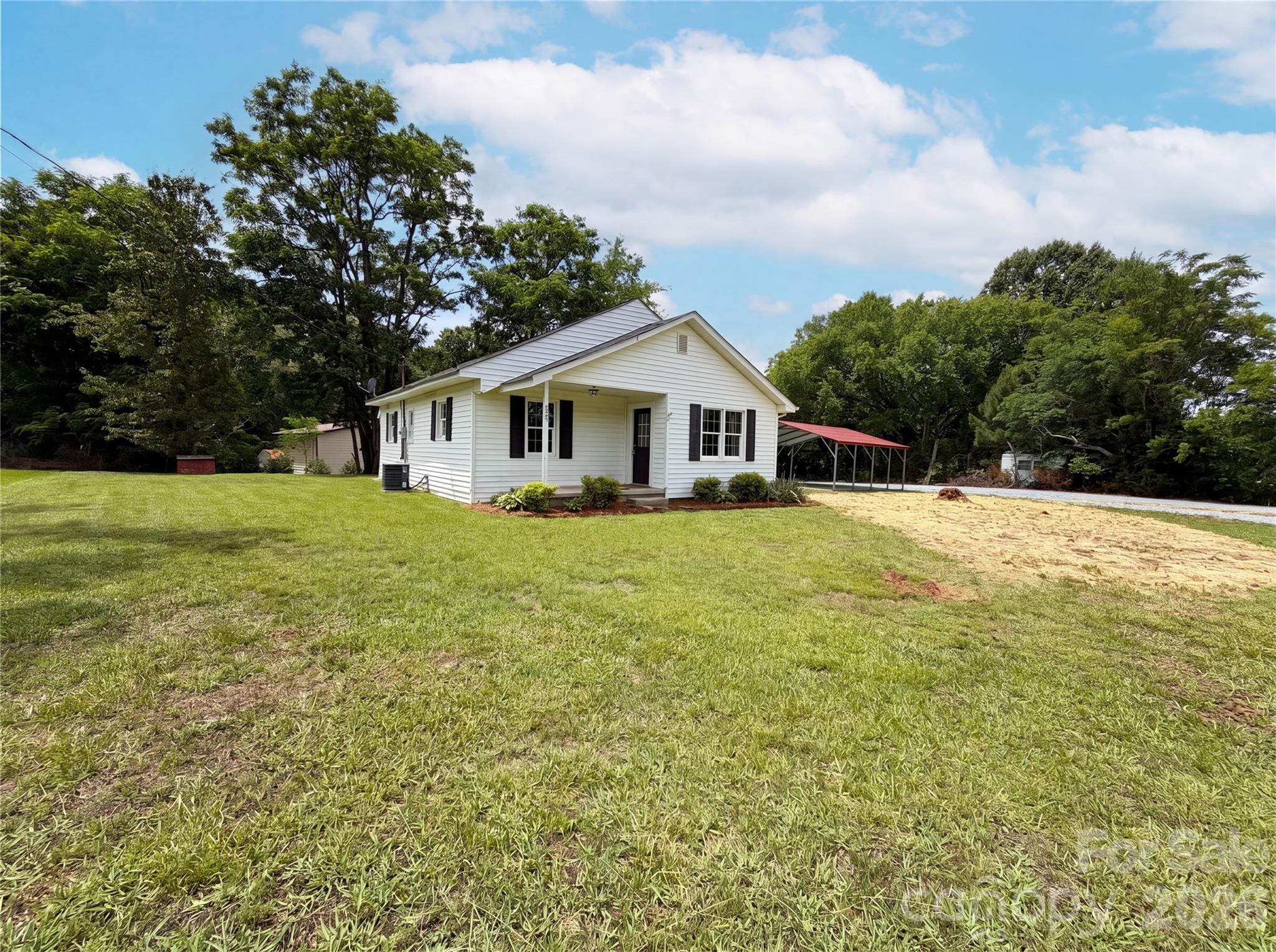 Charming 2-bedroom ranch home in desirable Mount Pleasant, NC! This inviting property features a bright, open floorplan that creates a seamless flow between the living, dining, and kitchen areas, making it perfect for everyday living and entertaining. Relax on the welcoming covered front porch and enjoy the peaceful surroundings. Outside, you'll find a detached covered carport and a spacious yard with plenty of room for gardening, outdoor activities, or simply enjoying the fresh air. With the convenience of one-level living and plenty of outdoor space, this home offers comfort, functionality, and small-town charm. Don't miss the opportunity to make this Mount Pleasant gem your own!