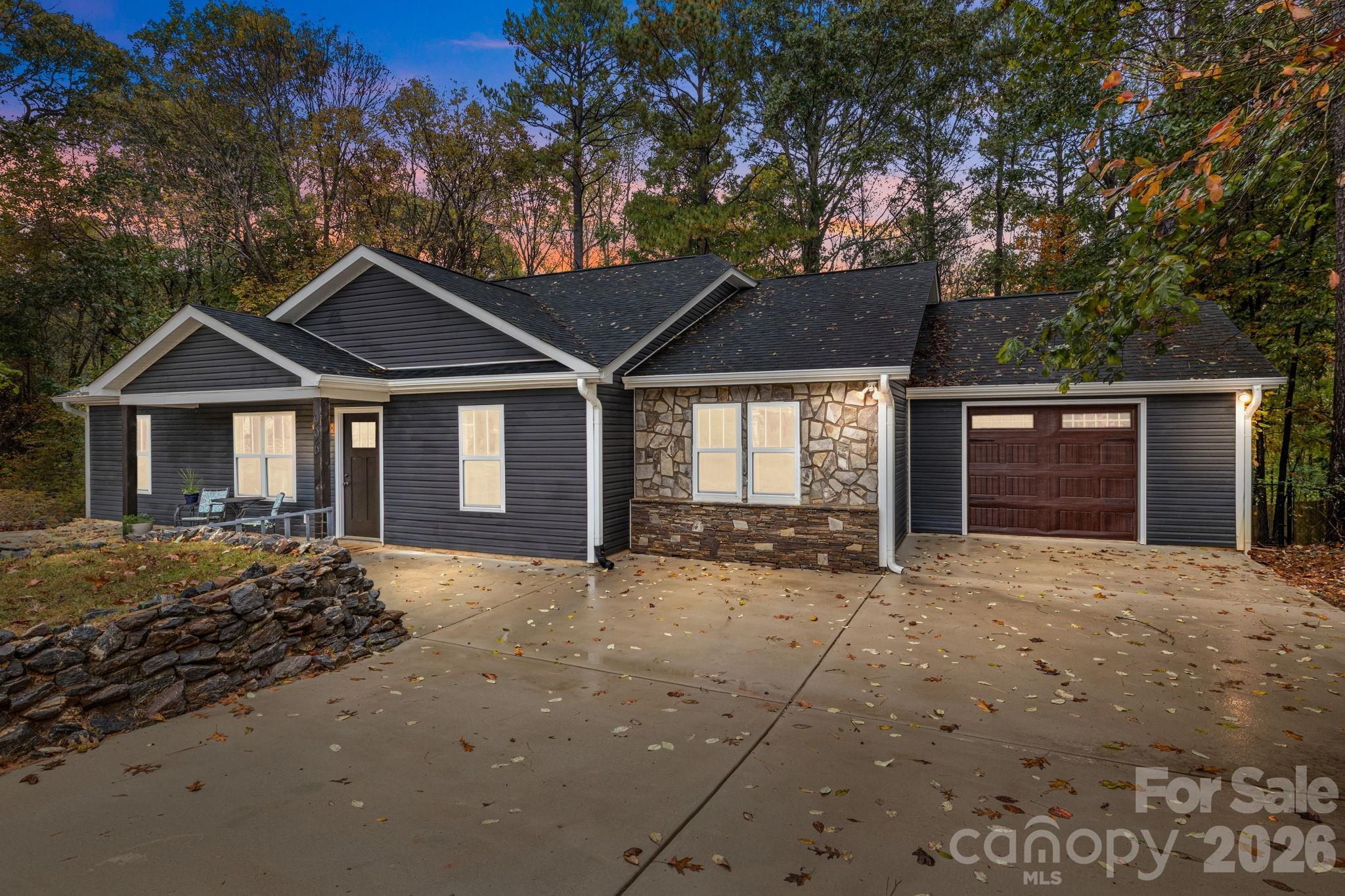 Step into a home that perfectly blends modern comfort, timeless charm, and everyday functionality. Nestled in the heart of Mooresville & a few minutes from the lake, this inviting 3-bedroom, 3-bath residence has been thoughtfully updated to blend everyday comfort with efficiency and peace of mind. You’ll love the light-filled spaces featuring durable LVP floors, a welcoming open-concept layout, and a stunning kitchen with quartz counters, a breakfast bar, and space that's ideal for family gatherings or entertaining.

Recent updates, including all-new windows, siding, and roof (2018), ensure lasting quality and curb appeal, while the tankless water heater brings modern convenience to your everyday life. Step outside to your covered porch—a peaceful retreat to enjoy Carolina evenings—or let pets roam safely in the fenced backyard. The 1-car garage provides added storage and easy parking.

From its inviting interiors to its thoughtful upgrades, every corner of this home radiates warmth and care. Schedule your private tour today!