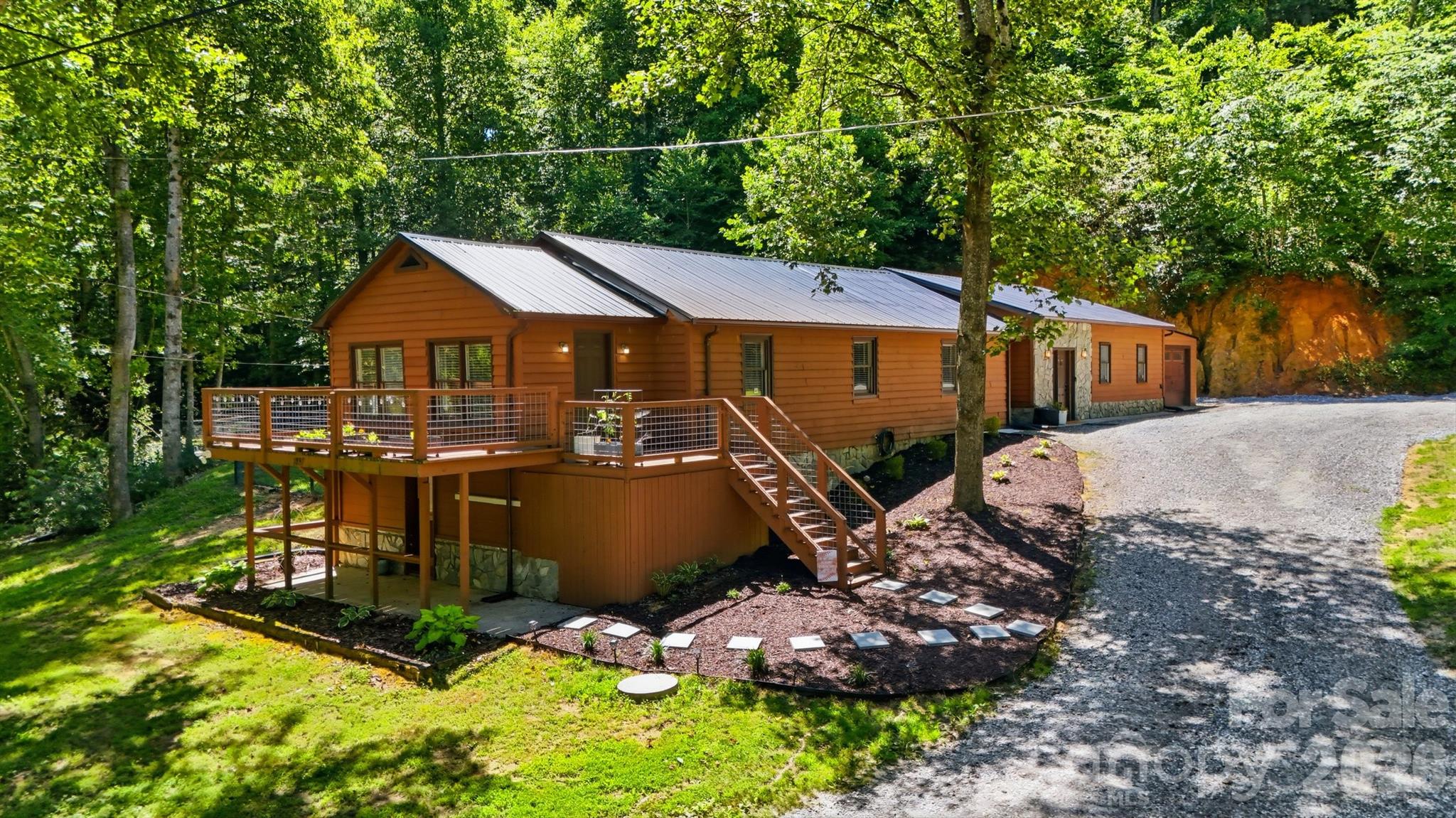 Discover a unique opportunity with this versatile 4-bedroom, 3-bath home designed for flexible living. Perfect for multigenerational households, the layout features one main entrance leading to two separately secured living spaces, each complete with its own kitchen, living room, and private living quarters.

The left side offers 2 bedrooms and 2 full bathrooms, while the right side includes 2 bedrooms and 1 full bathroom, providing privacy and independence for extended family, guests, or potential rental possibilities. The design may also lend itself to conversion into a duplex, subject to local regulations and approvals.

Both living spaces enjoy access to an expansive rear deck that spans the length of the home, complete with a hot tub overlooking a large, tree-lined backyard. Surrounded by nature, this peaceful setting offers the feeling of a private retreat while remaining just minutes from shopping, dining, and everyday conveniences. Enjoy the perfect blend of privacy, flexibility, and convenience in a location that feels like your own secluded getaway.
