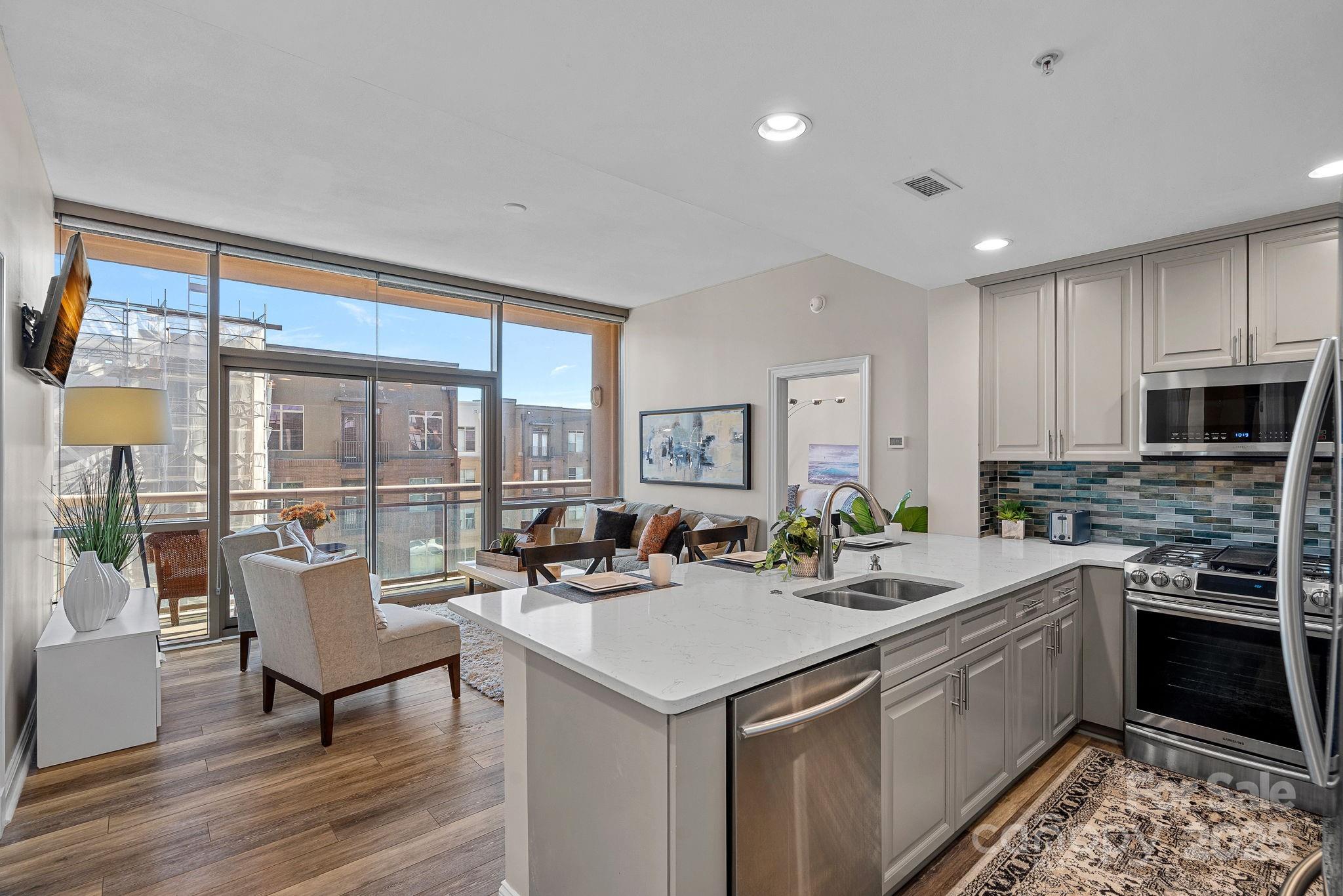 Experience luxury living in this beautifully updated two-bedroom condo at The Arlington—South End’s iconic "Pink Building." Ideally situated near Uptown close to the Bland street light rail station, this stunning residence features modern upgrades to the kitchen, bathrooms, and the primary bedroom’s custom-designed closet.

Residents enjoy top-tier amenities, including a rooftop pool, a state-of-the-art fitness center, a 5th-floor terrace, and a rooftop terrace offering breathtaking city views. The HOA covers water, natural gas, amenity maintenance, onsite association staff, professional management, and association insurance for a seamless living experience.

Furniture is negotiable, making this a rare opportunity to move into a stylish, move-in-ready home in one of Charlotte’s most sought-after locations. See MLS attachments for material info.