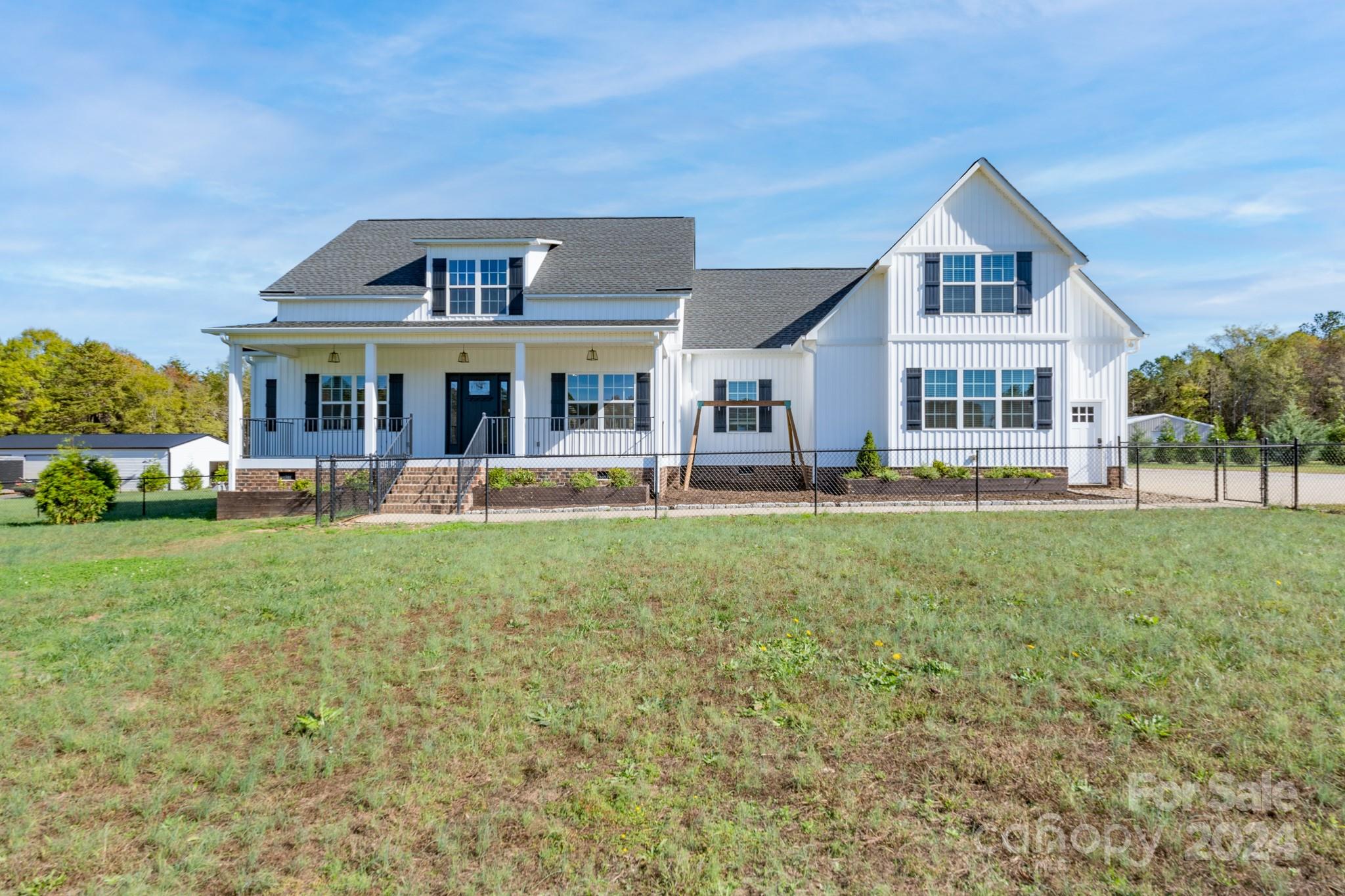 This modern farmhouse is such a unique property that is sure to impress!  The main floor features a family room with fireplace that opens to the kitchen, breakfast area, and dining room.  A spacious primary suite includes a shower, soaking tub, and double vanities.  Three additional bedrooms and a second bath complete the main floor.  Upstairs is home to an expansive bonus room and full bath.  The covered back porch provides an amazing entertainment space that overlooks a private oasis including a sparkling pool with cascading water.  A detached second living quarters features a beautiful kitchen, bedroom, two baths, and sitting room as well as a custom-designed closet, plantation shutters, and screened porch.  This space can provide awesome possibilities for the new owners.  An oversized double garage is attached to the home and there is an additional detached garage with over 1400 square feet of workshop space.  Come see all this property - that includes over five acres - offers you!