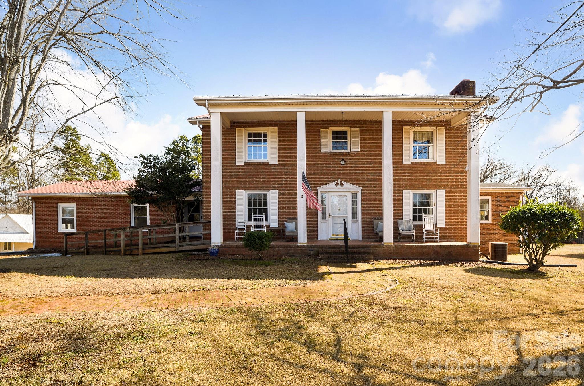 10 acres of endless possibilities 2 miles from I-40. Homesteaders, equestrians, multigenerational households, developers, or simply enjoy the peace and privacy. Two parcels combined to create a rare opportunity with land, multiple structures and room to expand. Front tract is 5.98 acres of flat, cleared land with approx. 243 feet of road frontage. Second tract with residence, large barn and outbuildings sits on 4.08 acres. House has 5 bedrooms, 3 garage spaces and circle driveway. House is 2,290 SF with a primary suite on the main level and a second primary ensuite on upper level. A 927 sq ft walkout unfinished basement with garage, full bathroom and game room not counted in living area. A second detached brick structure for home business, in-law suite or rental income. The accessory building offers 739 sq ft. with living area, kitchen, bedrooms, and laundry-shares septic and no permits on file so technically "unheated living area". Sunroom, pantry, porches, full bathroom & game room in unfinished basement also not included in living area. Strong bones and built to last, this property has been cherished by one family yet ready for your fresh vision!