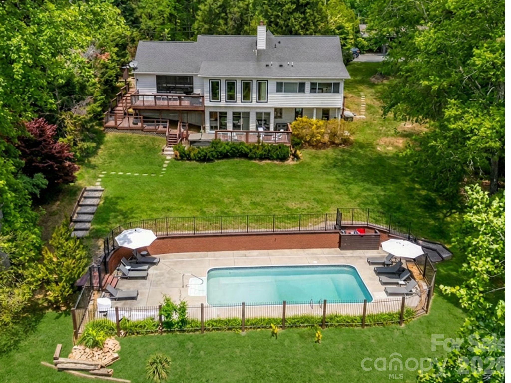 Discover a modern vacation oasis in the heart of Western North Carolina. Ideally situated just 15 minutes from the airport, this home offers easy access to Asheville's vibrant culture and culinary scene (30 minutes away) and the breathtaking waterfalls of Transylvania County (an hour's drive).

Offered as a turnkey short-term rental, this five-bedroom, five-bathroom property is the perfect mountain retreat. It features seamless indoor-outdoor living, dedicated gaming and recreation areas, a private pool, and more, ensuring something for every guest.

As an active rental, future showing availability will depend on guest reservations.