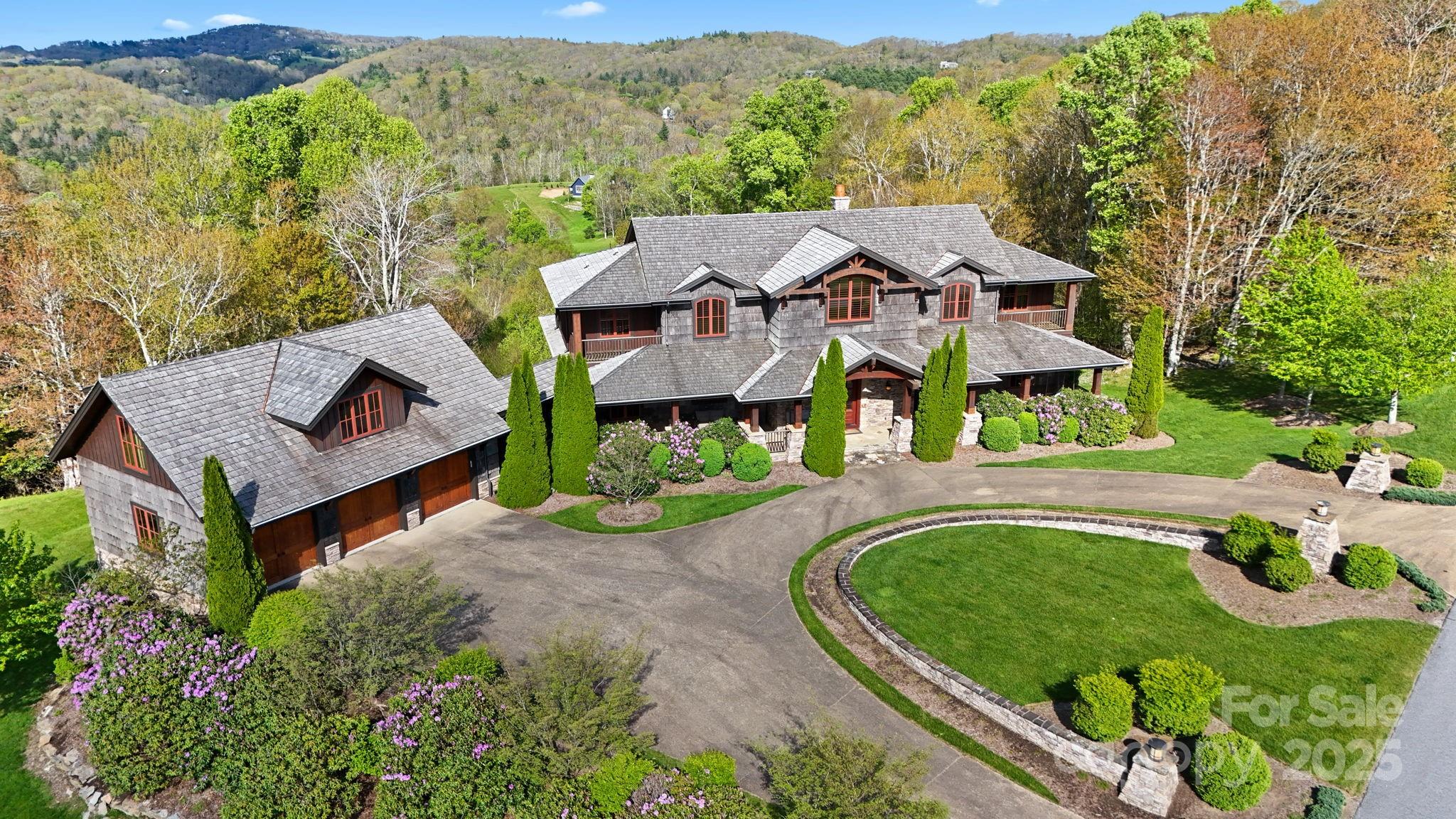 Thunderhill Manor – an upscale mountain retreat near downtown Blowing Rock and the Blue Ridge Parkway (5 minutes!), offering long-range, layered views of the Blue Ridge Mountains. This 6BR/6BA/2HBA estate (including 5 ensuite bedrooms, each with private decks/balconies!) is ideal as a luxury getaway or full-time residence in the prestigious gated Firethorn community. Enjoy year-round access on paved roads and convenient one-level living with all main amenities on the walk-in floor. FURNISHED, with exceptions! The main level features a dramatic great room with a cathedral ceiling, exposed beams, a wall of windows framing the views, and a grand stone fireplace—open to the dining area and chef’s kitchen with Viking appliances, granite counters, and walk-in pantry. A spacious Ipe deck includes a stone fireplace, built-in grill, and outdoor TV—perfect for entertaining. The main-level primary suite offers a private deck, stone fireplace, walk-in closet, and jetted soaking tub. Also on this level: a half bath, laundry room, large mudroom/breezeway to the garage, and an unfinished spacious apartment above. Upstairs, you’ll find a loft and four ensuite bedrooms with private decks and full baths. The lower level includes a living room with a coffered ceiling, a stone fireplace, and access to a stone patio and usable yard. Designed for entertaining, this level also boasts a wet bar with granite counters and seating, a spacious home theater with leather recliners, a bonus/exercise room, and an additional bedroom and full bath. A circular driveway provides easy access to the attached 3-car garage. Below, a large storage room with double doors offers space for equipment, small vehicles, or a future workshop. Additional features: high elevation (3,600+ ft), elevator to all three levels, covered entry porch, Rinnai tankless water heater, and Britta Pro water softening and filtration systems. Roof and poplar bark siding cleaned and sealed in August 2025! Firethorn community amenities: gate & gatehouse, clubhouse, walking trails, trout fishing.