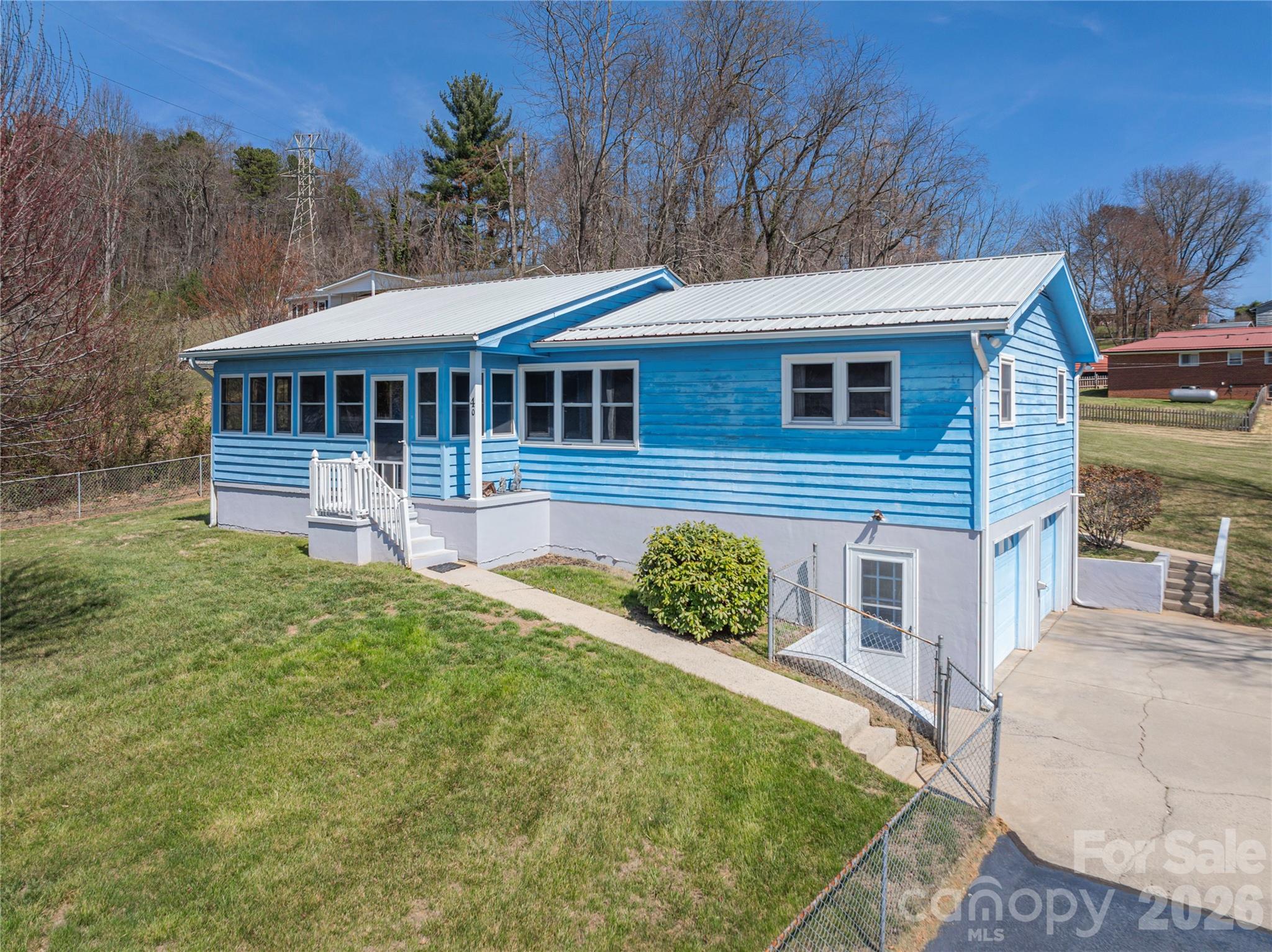 MOTIVATED SELLERS!!! 

Welcome home to this beautifully maintained Ranch nestled on 0.41 acres in the heart of Canton. With a spacious, lush green fenced-in-yard and mountain views as your backdrop, this property offers the perfect blend of comfort, character, function, and everyday charm. Inside, you'll find an open and airy floor plan designed for connection - featuring a galley kitchen with custom cabinetry, generous counter space, gas range, and a seamless flow into the dining area. Whether you're hosting or enjoying a quiet night in, this space feels both practical and inviting.

The main level offers three bedrooms, while partially finished walk-out basement expands your living options with an additional finished, heated and cooled 253 sq ft featuring a bedroom and full bath (not included in the total 1,385 HLA due to basement access through unfinished space) - ideal for guests, a home office, or multi-generational living. 

Start your mornings on the enclosed front porch and unwind in the evenings on the covered rear deck, surrounded by peaceful outdoor space that's ready for gatherings, pets, or simply soaking in the fresh mountain air. 

Conveniently located just minutes from dining, shopping, and everyday essentials, this home offers the ease of in-town living with the comfort of a tucked-away setting.