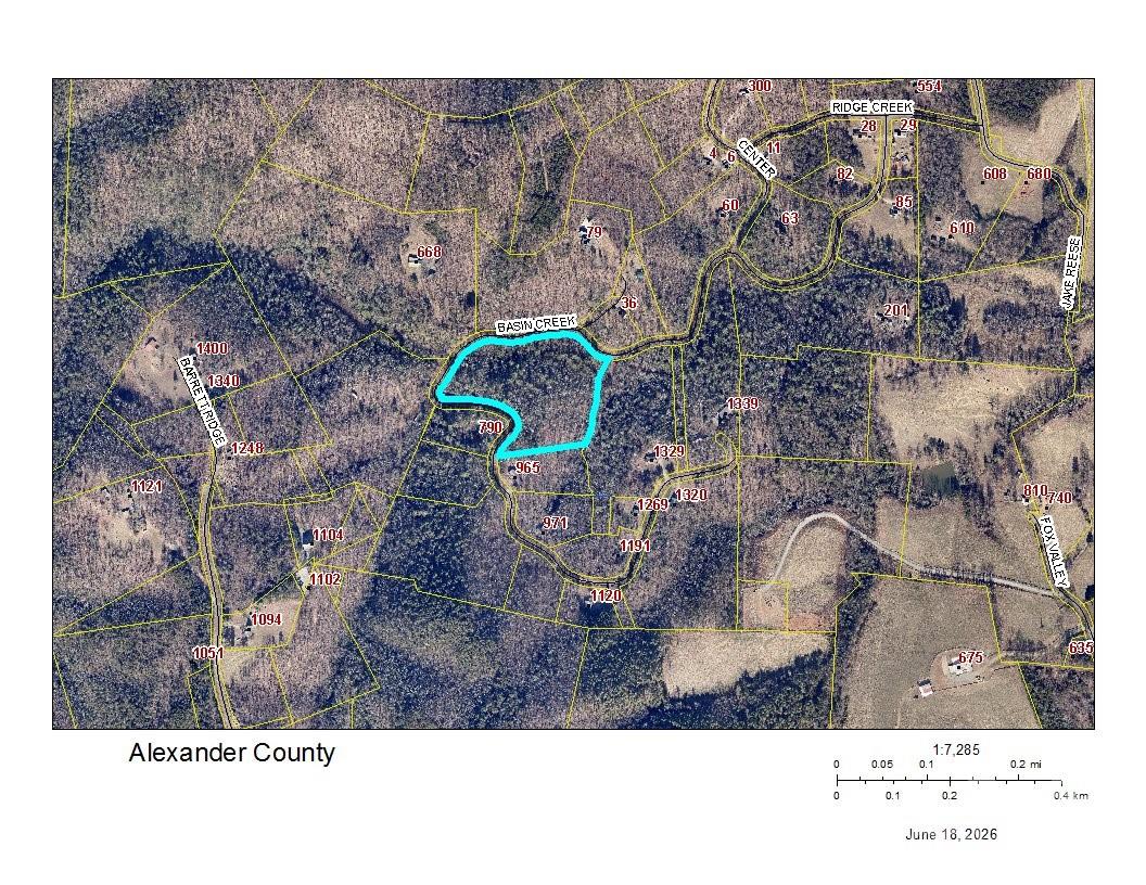 Escape to your own private mountain retreat on this 11.34-acre tract along Basin Creek Drive, featuring a rare combination of natural beauty, usable land, and ready-to-enjoy outdoor amenities. A flowing creek winds through the property, leading to a picturesque waterfall that creates a peaceful, year-round soundtrack. The setting is serene, secluded, and truly one-of-a-kind.

A charming wood-built camping porch and patio sits perfectly positioned above the creek and waterfall area, offering a relaxing place to unwind, gather, or simply take in the sights and sounds of nature. Whether you envision weekend camping, a future cabin, or a full-time residence, this feature gives you an immediate space to enjoy the property from day one.

The land offers multiple potential building sites, a mix of mature hardwoods, and plenty of room for trails, gardens, or recreational use. With over eleven acres, you’ll have the privacy and space to create your ideal mountain escape.