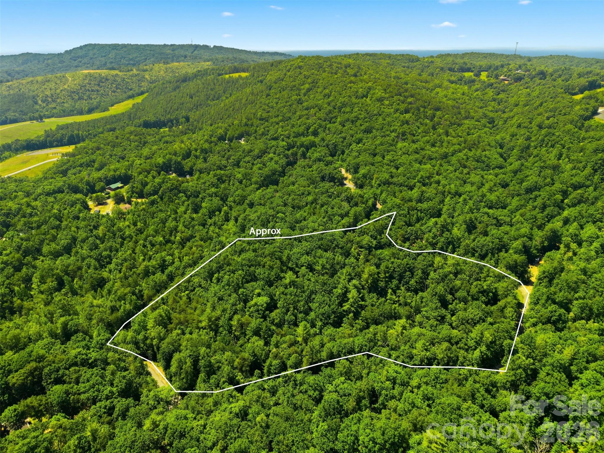 Escape to your own private mountain retreat on this 11.34-acre tract along Basin Creek Drive, featuring a rare combination of natural beauty, usable land, and ready-to-enjoy outdoor amenities. A flowing creek winds through the property, leading to a picturesque waterfall that creates a peaceful, year-round soundtrack. The setting is serene, secluded, and truly one-of-a-kind.

A charming wood-built camping porch and patio sits perfectly positioned above the creek and waterfall area, offering a relaxing place to unwind, gather, or simply take in the sights and sounds of nature. Whether you envision weekend camping, a future cabin, or a full-time residence, this feature gives you an immediate space to enjoy the property from day one.

The land offers multiple potential building sites, a mix of mature hardwoods, and plenty of room for trails, gardens, or recreational use. With over eleven acres, you’ll have the privacy and space to create your ideal mountain escape.