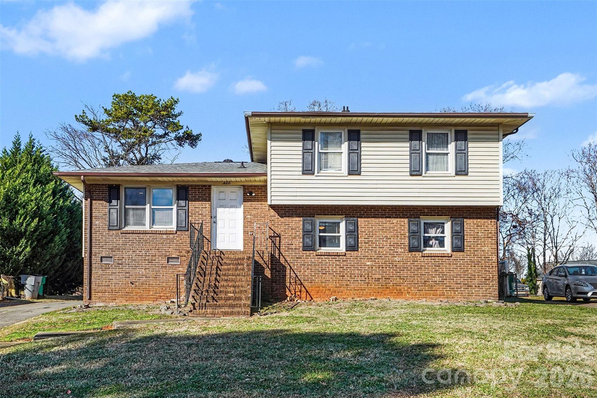 Welcome home to 420 Colony Acres Drive in Charlotte, a beautifully updated 4-bedroom, 2-bath residence offering flexible living and modern finishes throughout, just 5 minutes from I-77. The updated kitchen features granite countertops, subway tile and stainless steel appliances, perfect for everyday living and entertaining. Upstairs you’ll find three spacious bedrooms, including the primary bedroom and a full bathroom with granite counters and dual vanity. The lower level boasts a large living room highlighted by a stunning floor-to-ceiling stone fireplace, along with a fourth bedroom and a bathroom featuring a walk-in shower. This thoughtfully designed home combines style, space, and comfort in a convenient location.