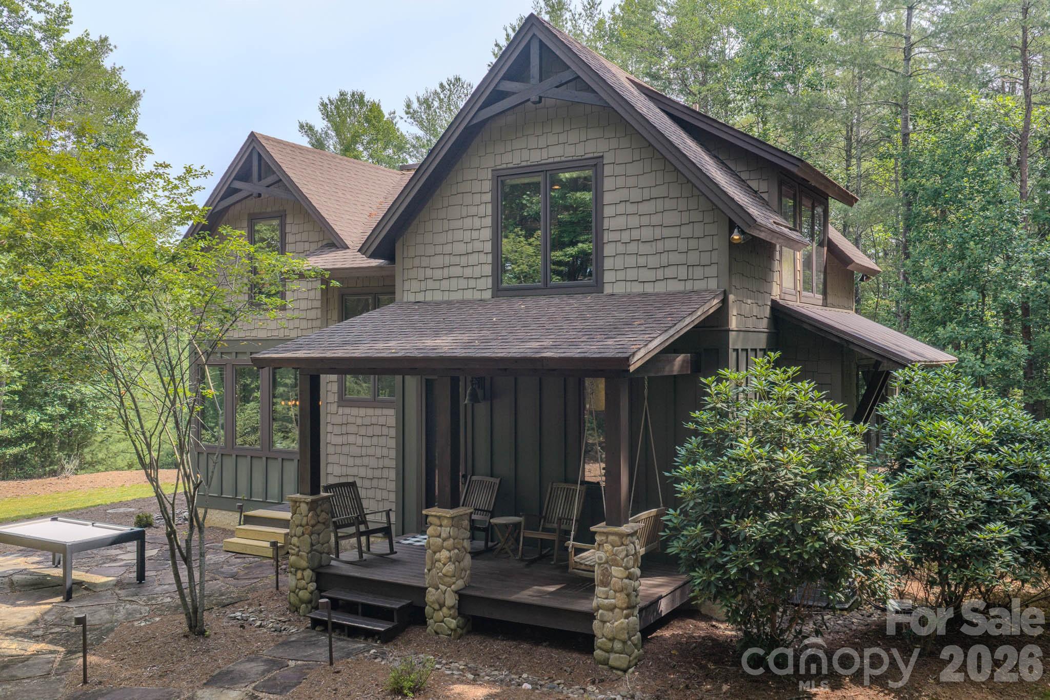 Located in the premier community of Old Wildlife Club on Lake James with deeded Boat Slip 9 Dock G just a short walk away. This well maintained & thoughtfully designed 4 bedroom/3 bath Cabin with detached storage building provide ample storage for Lake living whether full time or seasonal enjoyment. Main living area has Great Room with wood burning fireplace, dining area with a wall of windows, well laid out kitchen w/stainless appliances, granite tops, walk in pantry. Laundry opens to covered side porch, fire pit with outside grill and tree house. Upstairs primary suite with 2 walk in closets, ensuite bath with dual vanities, tiled shower with 2 additional bedrooms and full bath. Hardwood flooring and tile throughout. Situated on 1.27 acres surrounded on two sides by conservation areas provides seasonal lake and mtn views. Encapsulated crawl space. Membership to Camp Lake James as a top attraction to Lake living in the mountains. High quality build in a beautiful mountain lake community with easy access to Asheville and Charlotte!
