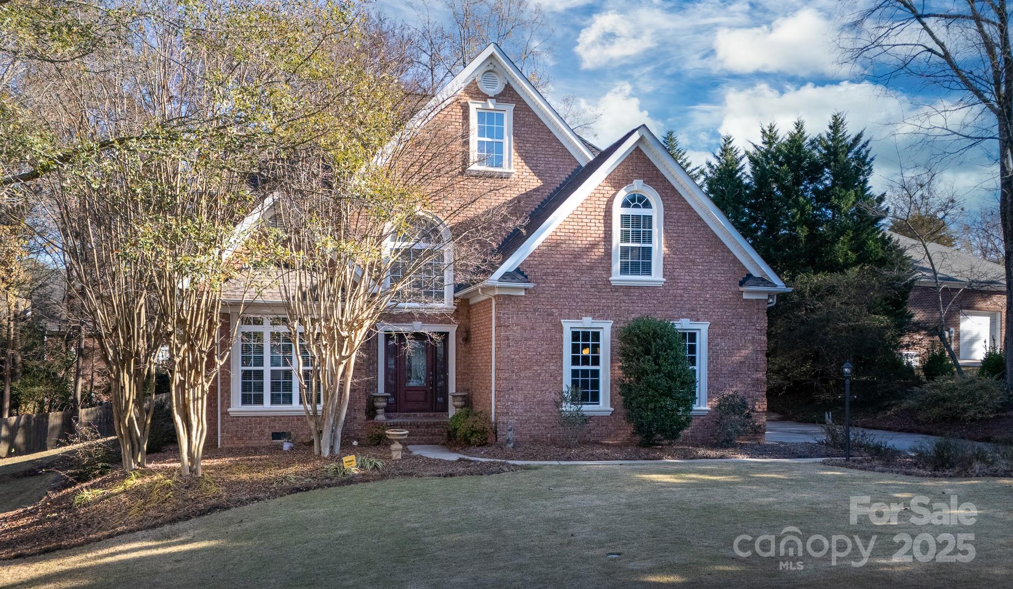 Welcome to this distinguished full-brick home, perfectly tucked away in a quiet Fort Mill cul-de-sac. The welcoming entrance foyer sets the stage for a floor plan designed for both entertaining and comfortable living. Host elegant dinners in the formal dining room, or gather for casual meals in the kitchen’s bright dining area. The kitchen serves as the heart of the home, featuring granite countertops, a breakfast bar, wall oven, walk-in pantry, and a dedicated desk area. The space flows naturally into a soaring two-story living room anchored by a cozy gas log fireplace, creating an impressive yet inviting atmosphere. Designed for flexibility, the main level offers a spacious home office and a convenient guest bedroom with a full bath. Upstairs, retreat to the expansive primary suite, boasting a double tray ceiling, dual sinks, a massive double shower, and a large walk-in closet. The upper level also features a versatile bonus room with a closet that can easily serve as a fifth bedroom or media space. With peace of mind provided by a 2020 downstairs HVAC and 2023 upstairs HVAC, plus a side-load two-car garage, this home is move-in ready. Enjoy the privacy of your location while remaining just moments away from the charm of downtown Fort Mill.