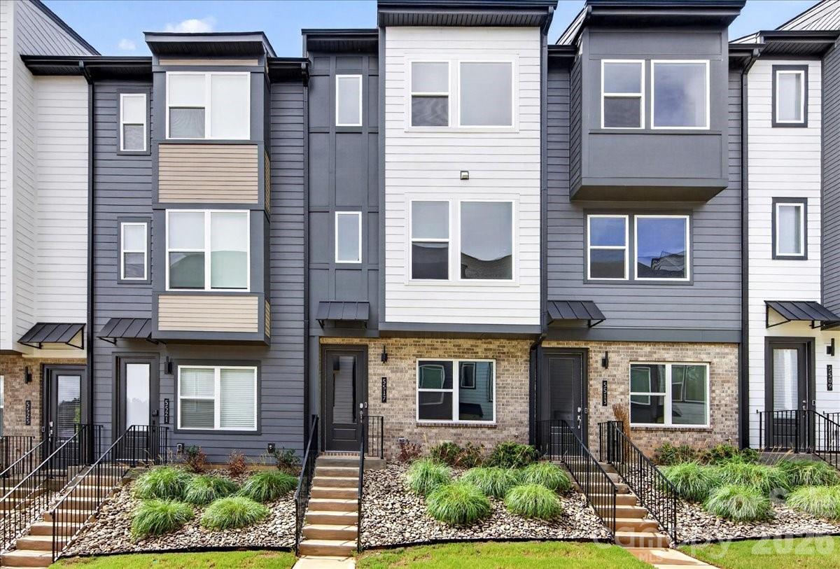 Welcome to 5517 Swaling St, a 4-story Merrill plan townhome nestled within the gated Southmont community in Charlotte, NC. Designed for low-maintenance living without sacrificing space or style, this 3-bedroom, 3.5-bathroom home spans 1,729 sq ft and includes a 2-bay tandem garage. Enter through the front door and oak box stairs will guide you to the heart of the home on the second floor, where a chef-inspired kitchen anchors the space with warm brown cabinetry, white quartz countertops, a large island with a single-bowl stainless steel sink, and an electric range. The living area extends outdoors to a balcony, perfect for morning coffee or evening unwinding, while a powder room completes the floor. Oak box stairs with open rails lead to the third floor, where the primary suite offers a serene retreat with a tiled walk-in shower and brown cabinetry, alongside a secondary bedroom with its own full bathroom. The fourth floor delivers added flexibility with a third bedroom and full bath, ideal for guests, a home office, or a bonus living space. A pickleball court, and a location close to Southend, SouthPark, local dining, shops, and the light rail make Southmont a place you'll love coming home to.