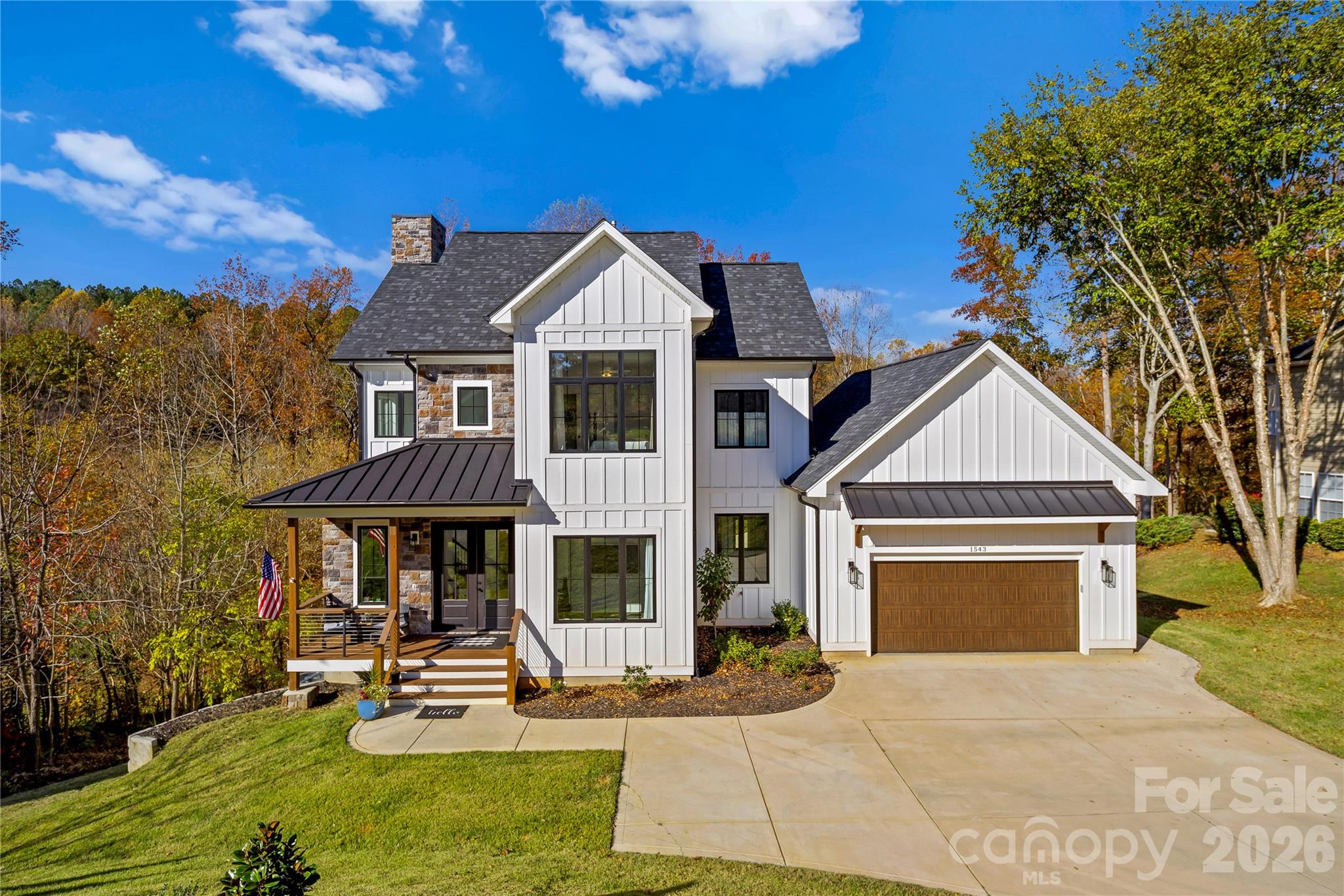 Experience modern elegance and breathtaking golf course views in this custom 2023-built masterpiece, perfectly situated on the 4th hole of Verdict Ridge Country Club. Nestled on a peaceful cul-de-sac, this 4-bedroom, 3.5-bath home boasts over 3,100 sq. ft. of thoughtfully designed living space, blending luxury and functionality at every turn. Step through the dramatic 20+ ft vaulted entry and into a light-filled interior that exudes contemporary sophistication. Dual offices/flex spaces offer versatility for work or study, while 10-ft ceilings, 8-ft doors, and oversized 8x12 sliders create an effortless flow between indoor and outdoor living. The open-concept design leads to a spacious sun deck, where you can take in panoramic views of the Virdict Ridge Golf Course and surrounding wooded landscape—a true sanctuary. The sleek kitchen, a modern chef’s dream, showcases quartz countertops, stainless steel appliances, and a butler pantry for seamless entertaining. Anchoring the great room is a striking floor-to-ceiling stone fireplace, adding warmth and style to this inviting space. Upstairs, the serene primary suite offers a private retreat with tranquil treetop vistas and a spa-inspired bath featuring a dual-head walk-in shower and overhead waterfall. The fully finished walkout basement expands your living options, complete with additional lounging areas, a covered porch, hot tub, and unrivaled views of the creek and golf course—your private escape to unwind. Thoughtful touches like a drop zone and laundry room ensure daily convenience without compromising on the home's sophisticated charm. This home is more than just a place to live; it’s a modern haven that perfectly balances elegance, comfort, and the beauty of golf course living.