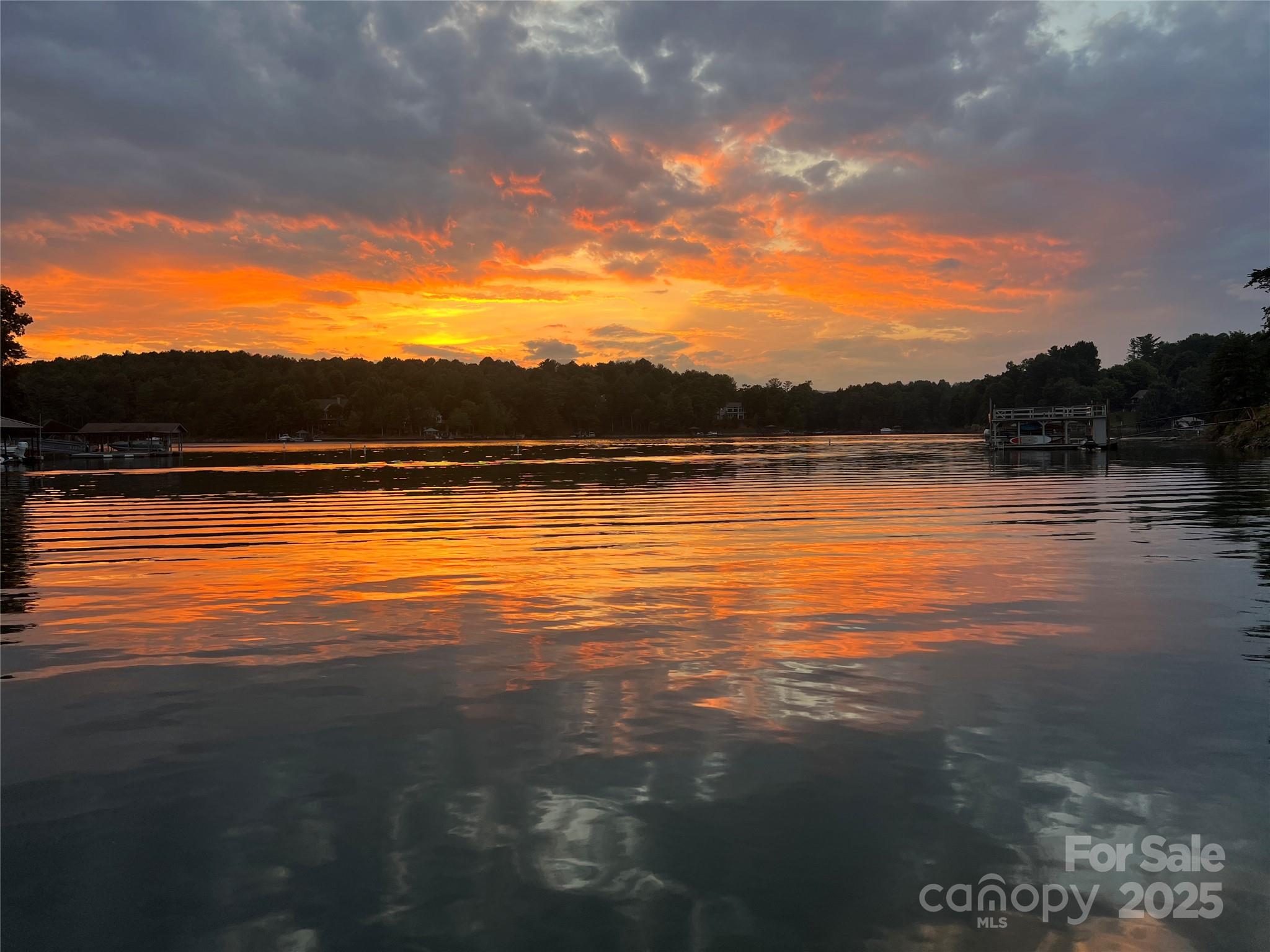 Come build your dream home on this lakefront property located in the premier East Shores Community of Lake James. Nestled in the serene mountains of Western North Carolina, tranquility awaits.
Lake James is at the foot of the Blue Ridge Mountains with nearly 6800 acres, 2/3 is a protected State preserve, with more than 150 miles of shoreline. 
Lake James is considered one of the most pristine lakes in the Southeast. The area is known for great water sports, fishing, plus hundreds of miles of hiking and biking trails.
East Shores has a total of 167 homesites and is a located on the southeast side of Lake James in Morganton, NC.  East Shores is only 15 minutes from the downtown area of Morganton and conveniently located off Interstate 40.  The neighborhood offers phenomenal views of the lake and the mountains, a pool, sport court. Asheville,
Winston-Salem and Charlotte are within a 1 -2 hour drive.
The East Shores community offers hi-speed Internet as well as city water.  This lot is .77 acres and has a current 3 BDRM septic permit on file. A topographical study has been completed. A floating dock exists for your immediate lake access.