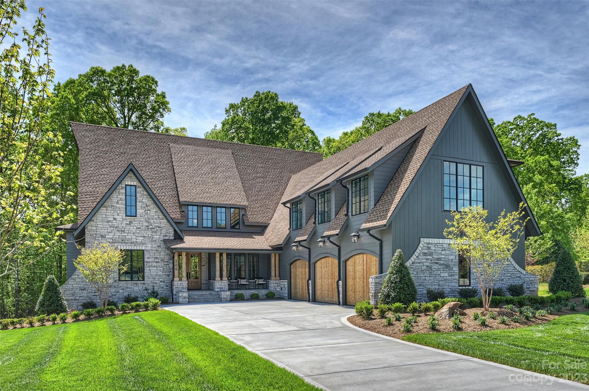 Experience extraordinary design & craftsmanship throughout this luxury estate home on a 1+ acre, cul-de-sac lot backing up to a private wooded area w/room for a pool. Main floor primary suite features a 12' tray ceiling w/ beams, a fabulous bath w/his & her vanities, free standing tub & an impressive 12' dual shower. A laundry area connects the 15x12' closet to the bathroom. Beautiful custom cabinetry, high end Thermador appliances, quartz tops, a large island, pantry & a scullery make this a dream kitchen for entertaining. Architectural archways define living areas yet they openly flow into one another. The great room has a 12' ceiling w/beams, a cast stone fireplace surround, built ins & a sliding glass door that opens to a gorgeous outdoor living area w/fireplace, slate tiled floor & optional screened area. Upper level offers 3 bedrooms with ensuite baths, walk in closets & the sweetest reading nook ever. A study area & laundry room are at the entrance of the gigantic bonus room!