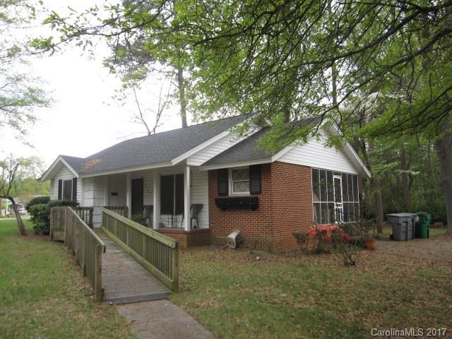 Charming well maintained exterior.  Inside in need of updates.  Large landscaped yard with side screened porch. Up and coming neighborhood, close to town and transportation.