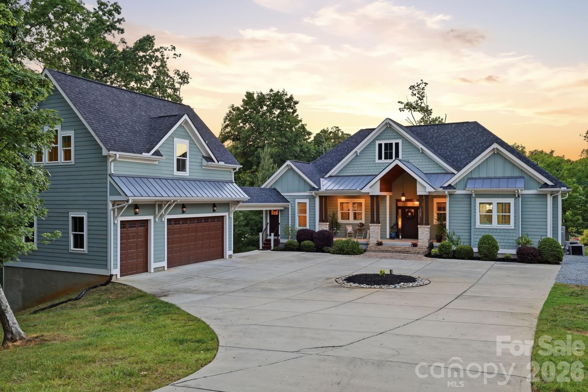 Welcome to lake life! This beautiful craftsman style home offers the best of ever day living and waterfront entertainment. Step from the walk out basement into an oasis on the water. Located in a quiet cove with views that open to the main channel just yards away! Wide open boating, skiing, jet skiing awaits. Multiple marinas a short ride away. 
The upgraded stationary dock offers covered space with built in cabinets and bar table with granite countertops, space for outdoor appliances if you wish. After a day of fun and sun on the lake you can retreat to the covered patio to cool off or the upper deck of the home and watch the amazing sunset reflections.  Frequent wildlife visitors such as Blue Heron, turtles, osprey and deer.
The open floor plan of the main floor has beautiful views of the lake from the entire back side of the house with large bright windows and doors. Gorgeous hardwood floors throughout. The primary bedroom is on the main floor with large bath, separate tub and shower, separate vanities, washer/dryer hook ups (1 of 2) in closet, walk in closet. A second bedroom on the main floor has its own full bath. A perfect guest room! 1/2 bath also on the main floor. 
The kitchen has a gas range, stainless hood, island with extra cabinets, soft close cabinets and drawers, and pantry. Lower level walk out finished basement has its own open floor plan with living room, 3rd bedroom, full bath, flex room (currently used as a 4th bedroom), exercise room/gym, Office with built ins, 2nd laundry.  Also, great views of the lake from the entire lower level. Easy access to the dock.
The garage, connected to the house by a covered breezeway, has plenty of space to park two large vehicles/trucks plus space for a golf cart or ATV. 2ND LIVING quarters above the garage with full kitchen and island seating. Full bath and its own laundry hookups. Hardwood floors and tiled bath. 2nd room currently used as 5th bedroom.
Convenient location with shopping and dining close by. Parks and highly rated schools.