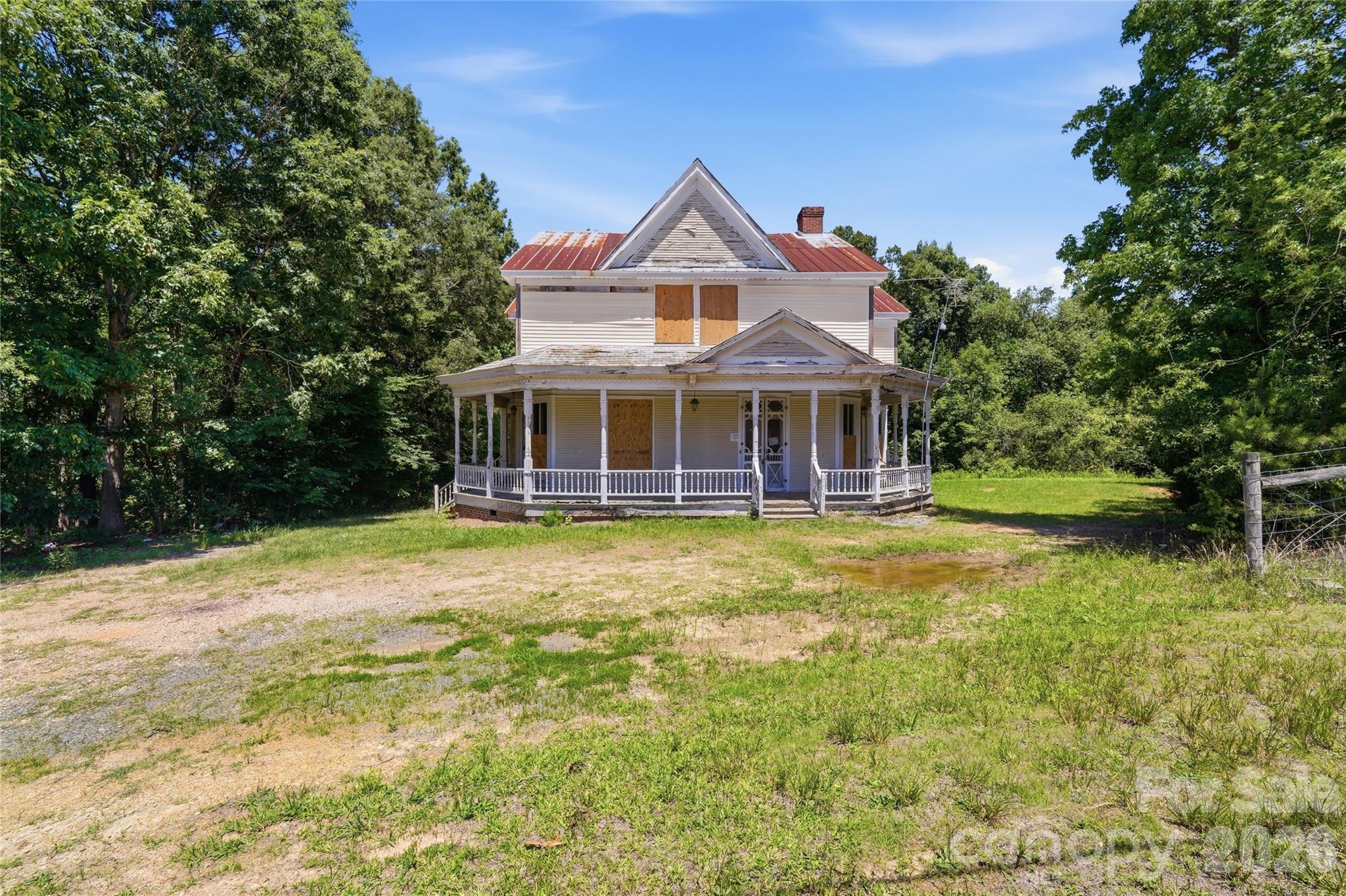 Historic Farmhouse on 2 Acres – Endless Potential in Union County!
Step back in time and imagine the possibilities with this charming historic farmhouse situated on a beautiful 2-acre lot in the desirable Monroe area. Rich with character and architectural detail, this spacious home features 4 bedrooms, 2 bathrooms, soaring ceilings, built-in cabinetry, and a classic wraparound front porch that welcomes you home.
The generous floor plan offers large living spaces, a formal dining room, an expansive kitchen area, and plenty of room to create your dream country estate, family home, or investment property. Outside, enjoy the privacy and tranquility of two acres with mature trees, open space, and room for gardens, workshops, recreational activities, or future improvements.
Conveniently located near historic Downtown Monroe, residents enjoy easy access to local restaurants, shopping, breweries, parks, and community events. Nearby attractions include Cane Creek Park for boating, fishing, hiking, and camping, along with convenient access to Waxhaw, Indian Trail, and the greater Charlotte metro area.
A rare opportunity to restore and customize a property filled with historic charm and timeless craftsmanship. Bring your vision and transform this remarkable farmhouse into something truly special!