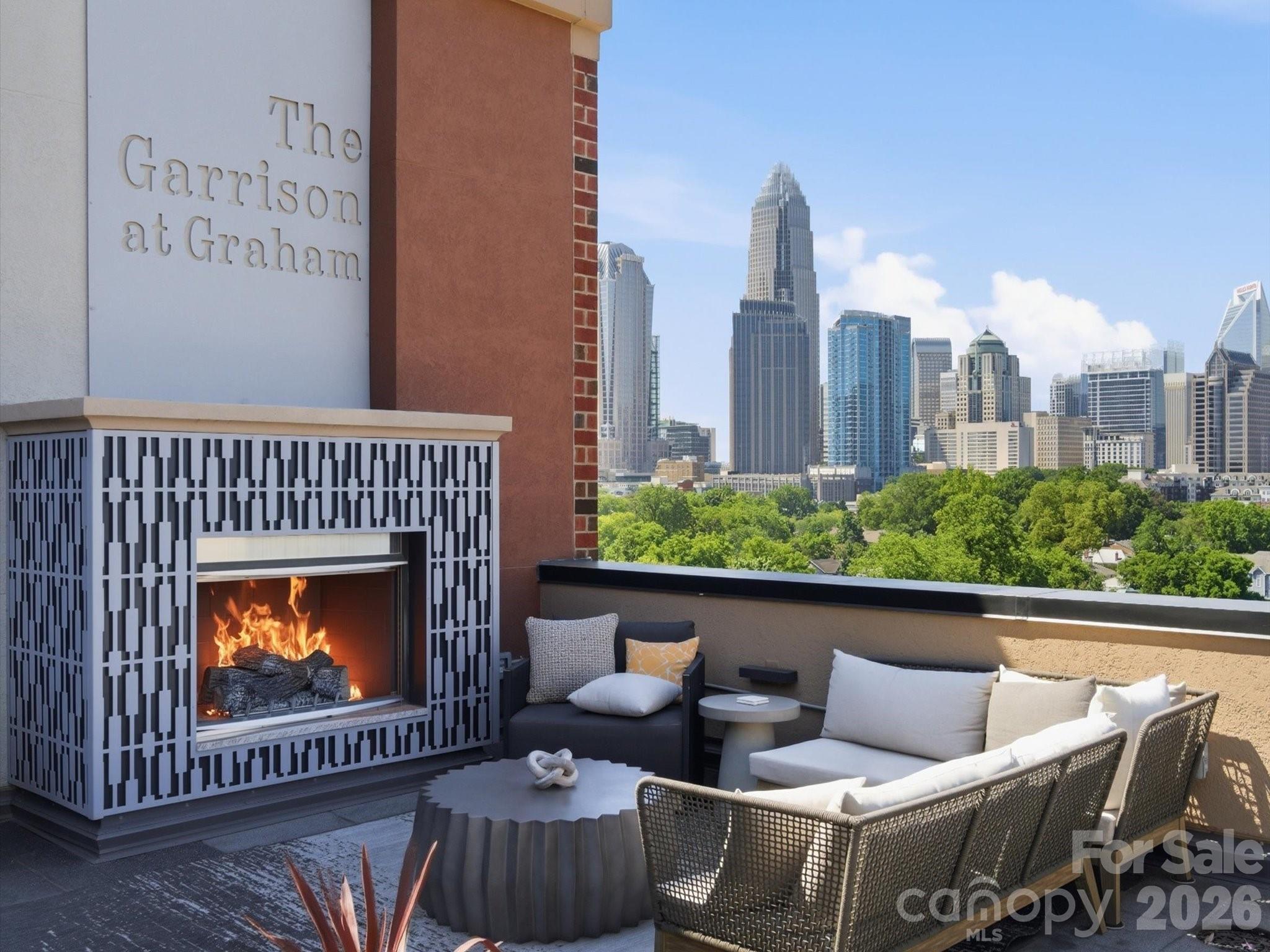 SELLER OFFERING $10K CREDIT for closing costs, rate buy down, etc.!  Additional credit available with use of preferred lender.  Discover urban living at its finest in this stunning 5th-floor residence at The Garrison at Graham, a gem in historic Fourth Ward. The chic industrial design is second only to the breathtaking skyline view, perfectly framed by a dramatic wall of windows.  The home features hardwood floors throughout and spacious, open living spaces.  The kitchen has an expansive island, granite countertops, tile backsplash, and stainless steel appliances.  A private guest bedroom or office is conveniently located on the main level adjacent to a full bathroom.  Upstairs, the lofted primary retreat includes a generous walk-in closet, laundry closet, and luxurious bath with large garden tub and separate shower.  Move-in ready with neutral paint and modern fixtures.
The Garrison is a gated community and unit 502 includes a dedicated parking spot in the garage - #40. The 6th-floor rooftop terrace is an ideal spot for residents to gather, entertain guests, work, or lounge, all with the city skyline as a gorgeous backdrop. It’s complete with grilling stations, cozy fireplaces, and seating areas.  The building amenities and interiors have been refreshed, offering a luxurious feel throughout.