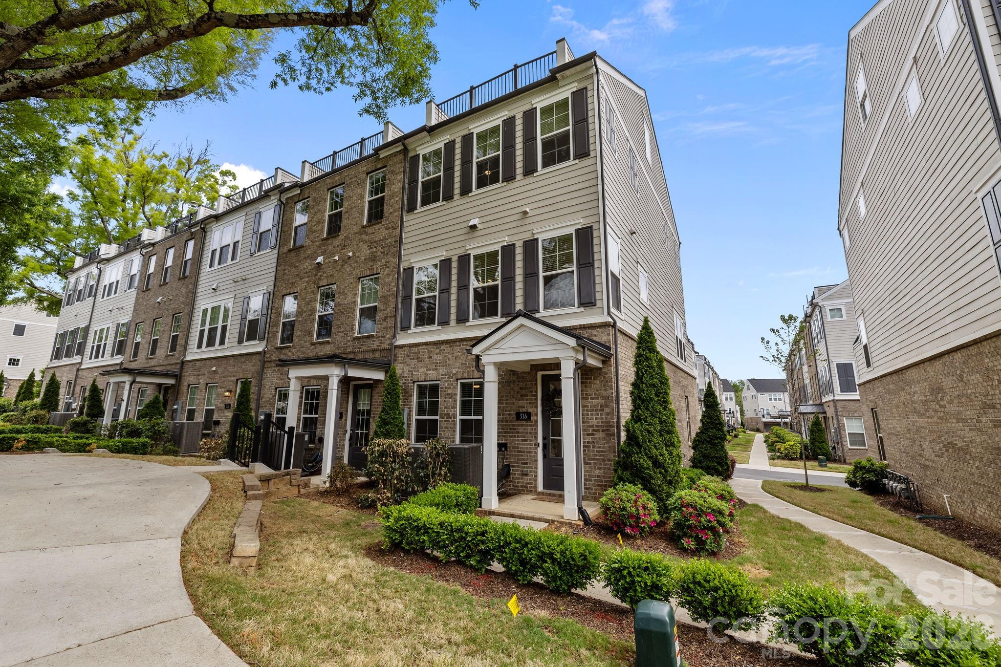 END UNIT sophistication in the heart of coveted Elizabeth. This refined townhome offers exceptional privacy & tranquil wooded views. A gracious foyer opens to a main-level BD w full BA—ideal for guests/private office—plus a 2-car garage w built-in storage. The 2nd level showcases elevated open-concept living w soaring ceilings, rich hardwoods & abundant natural light . The chef’s kitchen features a generous pantry, built-in refrigerator, 6-burner gas range & expansive island with seating, flowing seamlessly into the living area, with private balcony for refined entertaining. The 3rd level offers a luxurious primary suite w spa-inspired BA & generous walk-in closet, plus a secondary BD w en-suite BA. The 4th level includes a versatile loft, powder room & private rooftop terrace. 2,200 sq ft of curated living in one of CLT’s most desirable neighborhoods!