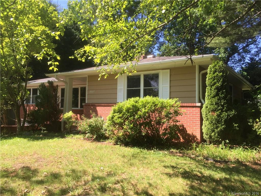 This charming 1950's bungalow features hardwood floors and a convenient location. Three bedrooms/ one and a half bath home is situated between downtown Hendersonville and Mountain Home. The main level features hardwood floors, gas log fireplace, spacious master bedroom and eat-in kitchen. The lower level basement has a family room, one car garage with workshop space, and a level/ fenced-in backyard.