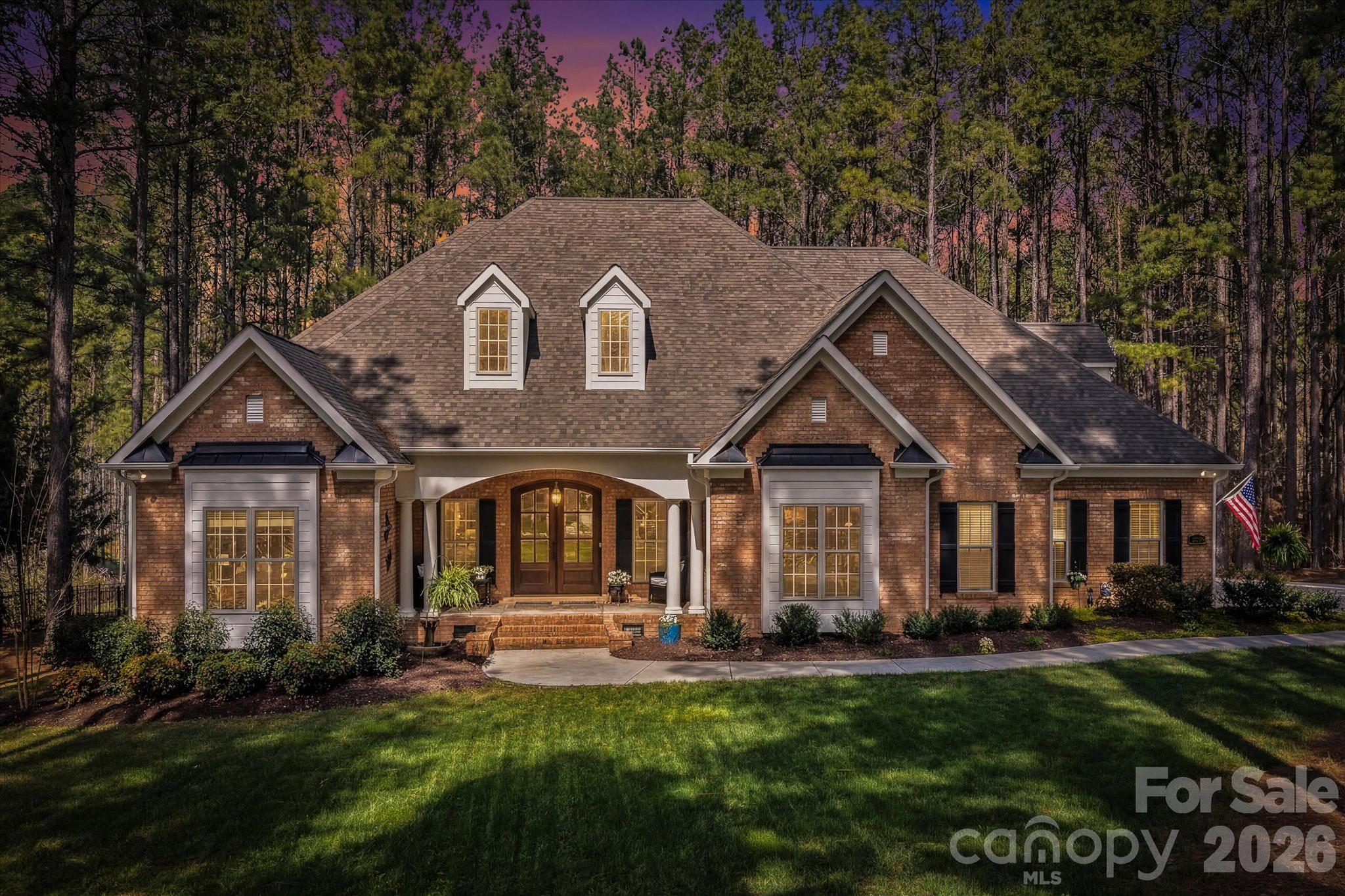 Experience Lake Norman living in a gated, lake-access community with private boat ramp and day dock—just minutes from everything, yet tucked into a peaceful wooded cul-de-sac.

PRE-INSPECTED for added confidence, this extensively updated and meticulously maintained home offers room to create a resort-style pool retreat.

Major improvements include two new HVAC systems (2023/24) with UV light air purification, fresh interior paint, new wood floors, designer interior/exterior lighting (2025), updated cabinetry, new hardware and plumbing fixtures, new bedroom carpet (2025), exterior paint (2025), and a new garage door, opener, and springs (2025).

Additional updates include a complete kitchen remodel, new deck and screened porch, a year-round swim spa and patio (2022), fencing (2022), and a fully encapsulated crawlspace.

This 4,484 sf full-brick home stands out with soaring 12’ ceilings, rich wood floors, designer lighting, and a floor-to-ceiling stone fireplace anchoring the main living space. The kitchen is designed for both everyday living and entertaining, featuring custom cabinetry, granite countertops, high-end appliances (gas stove top), a large breakfast bar, and a dedicated coffee and wine bar—all overlooking the private backyard.

Main-level living includes a spacious primary suite with sitting area, custom walk-in closet, and spa-like bath with dual vanities, stone shower, and jetted tub. Additional spaces include a dedicated office, bonus room, stylish bar/lounge, secondary en-suite, and two additional generously sized bedrooms.

Outdoor living is where this home truly shines—a large deck, screened porch nestled among the trees, patio, fire pit, year-round swim spa, and fenced backyard extending beyond the current fence line create a private retreat that’s hard to find at this price point 

Located just 3–4 miles from shopping, dining, and daily conveniences, with an easy commute to Charlotte—this home offers the lifestyle buyers are looking for, without compromise.