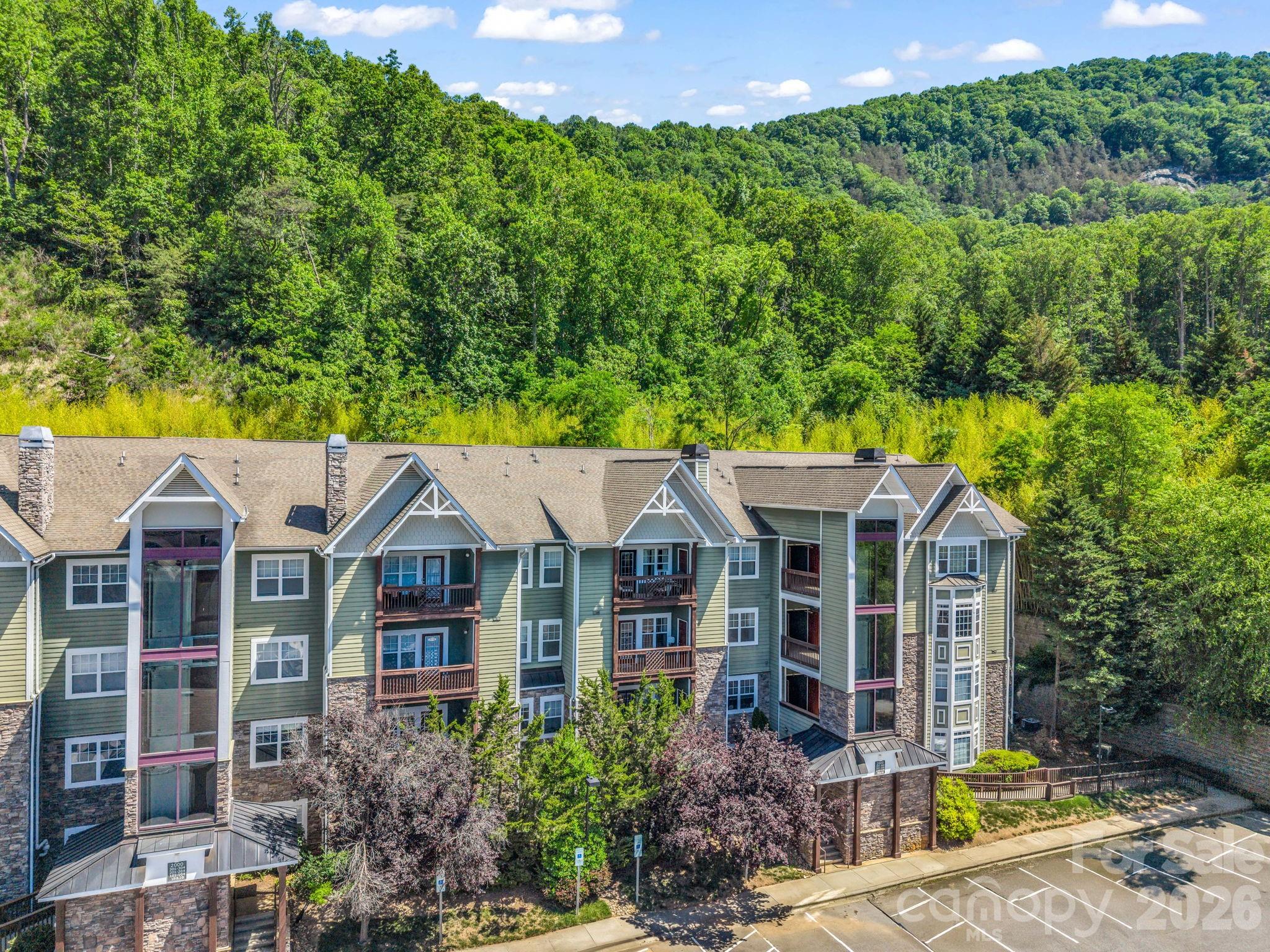 Stunning, remodeled main floor condo offering effortless luxury ,premium accessibility and tax savings too!
 Located outside of Asheville city limits-meaning NO city taxes. This unit went thru a transformation in 2023 featuring gorgeous new flooring, all new stainless appliances and new washer & dryer, and 2 beautifully upgraded bathrooms featuring custom walk-in shower and a low-threshold step in shower. Coupled with a 2023 HVAC and water heater,  and a highly coveted detached garage, this home is entirely turn-key with zero deferred maintenance. Enjoy a maintenance free lifestyle just minutes from Blue Ridge Parkway and I-40.
New window treatments throughout.