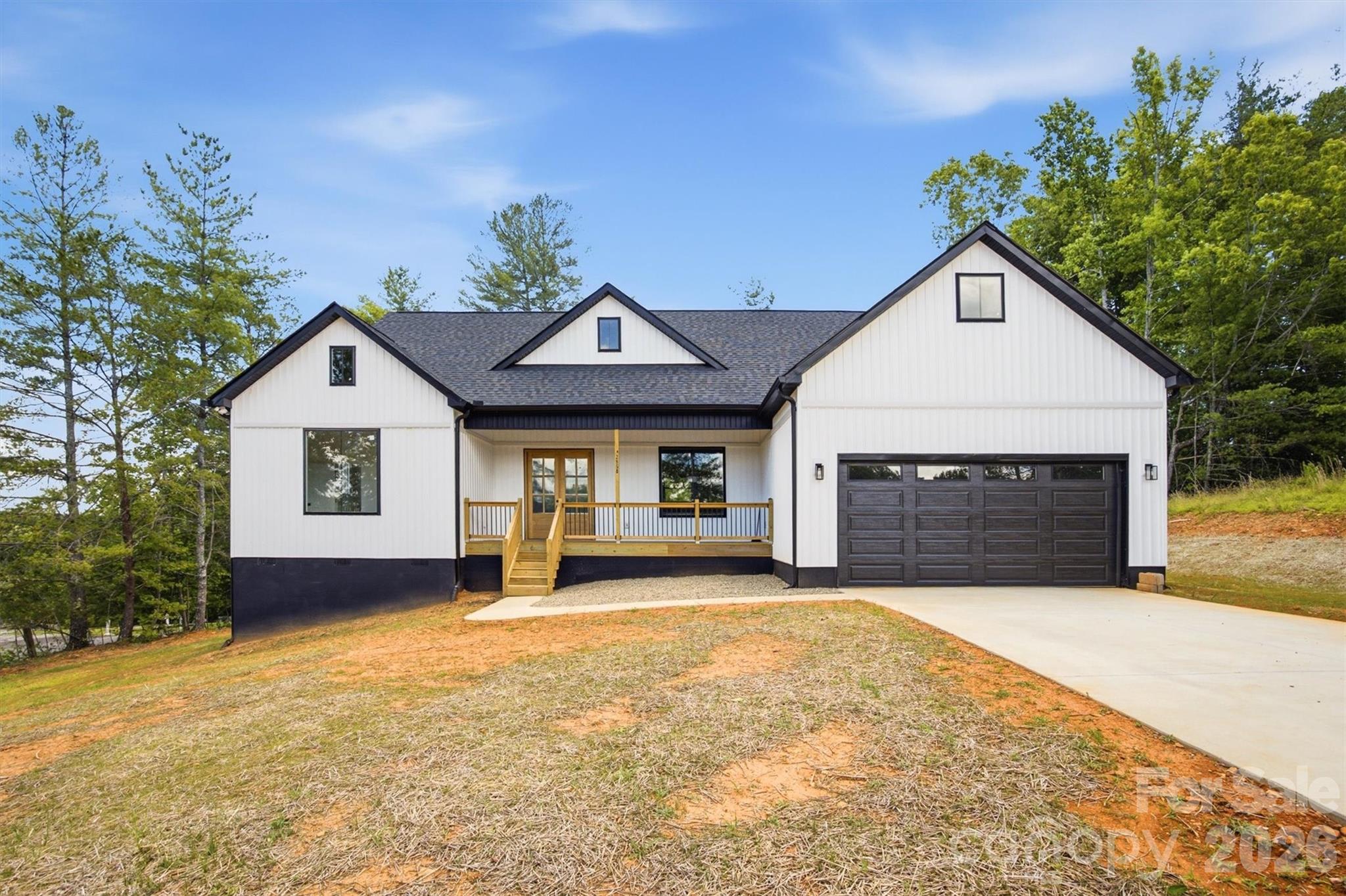 Gorgeous New Construction Home Only Minutes from Lake James!  Come see this thoughtfully designed farmhouse-style home offering the secluded feel of a country setting but just minutes from I-40 and the lake. Large covered porches on both the front and back of the home give you options on where to perch your rocking chairs for either morning coffee or an evening cocktail. As you enter the home, you'll be struck by the soaring ceilings and extra tall sliding doors in the great room that let in tons of natural light and leads to a huge covered porch overlooking the private backyard. The open kitchen features custom cabinetry, quartz countertops, stainless Frigidaire appliances, and a large island with a breakfast bar. For more formal dining, there's also a separate dining room conveniently located off the kitchen. With mostly single-level living, the split bedroom floorplan offers a main level primary suite w/ an en-suite bathroom offering both a soaking tub and a large tile shower as well as a massive walk-in closet.  On the opposite side of the home, you'll find two spacious guest bedrooms that share a jack & jill full bathroom as well as a half bathroom for guests and a separate laundry room. This space leads to the two-car garage with a storage closet and ample attic space above for storage.  The loft offers two separate rooms with endless possibilities, from a home office, craft room, home gym, or play room for kids & grandkids.  While construction on this home is complete, the builder is offering the new owners a choice of glass/doors for the showers and shelving for the closets; as well as pulls/handles for the kitchen cabinets.  Whether you're searching for a weekend retreat, a peaceful forever home, or an income-producing rental property, this brand new home is the place to Live the Lake James lifestyle!