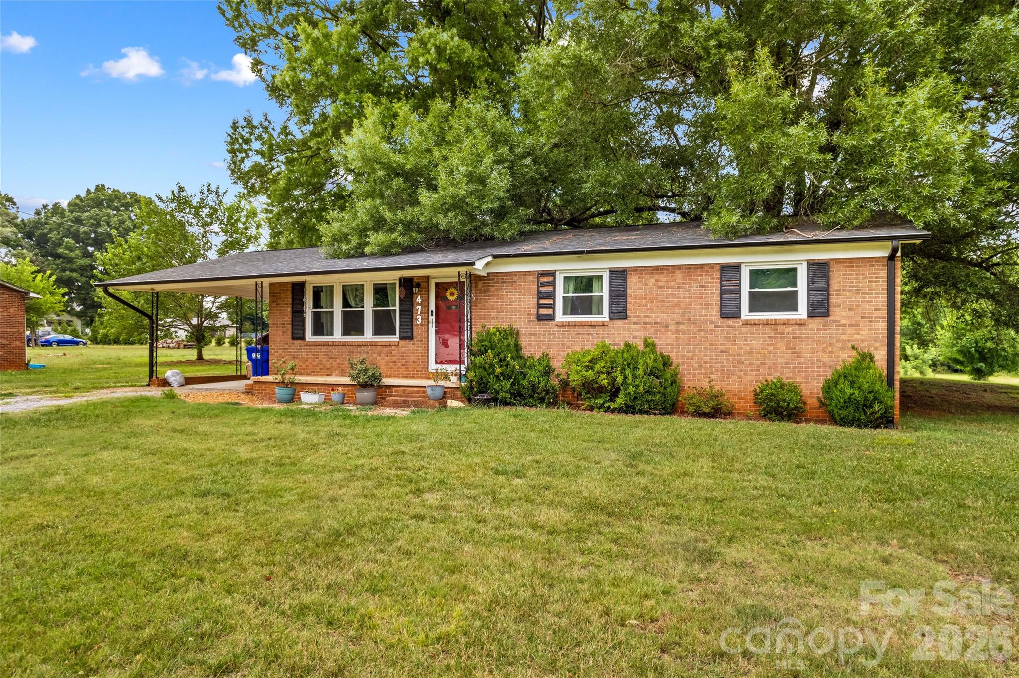 Welcome to this charming brick ranch in Statesville! Offering 3 bedrooms and 1 bath, this home provides the convenience of one-level living with a functional layout designed for everyday comfort. Inside, you'll find a bright living room, a dedicated dining area, and a practical kitchen with stainless refrigerator. The layout offers a great opportunity to add your own style and make the space your own.

Outside, you'll appreciate the covered front porch, the perfect spot to enjoy your morning coffee or unwind at the end of the day. The attached carport provides sheltered parking and includes a convenient laundry area with washer and dryer conveying, while the detached outbuilding offers valuable extra storage for tools, equipment, or seasonal items. The spacious yard offers plenty of room for gardening, recreation, outdoor entertaining, or simply enjoying the open space.

Recent updates include a roof in 2023, windows in 2023, and an updated walk-in shower in 2023, adding to the home's appeal. Central air was installed around 2021, providing year-round comfort.

Conveniently located with access to shopping, dining, and major roadways, this property combines the appeal of extra outdoor space with the convenience of nearby amenities. Whether you're searching for your next home or an investment opportunity, this inviting brick ranch offers plenty of potential and is ready for your personal touch. Schedule your showing today!