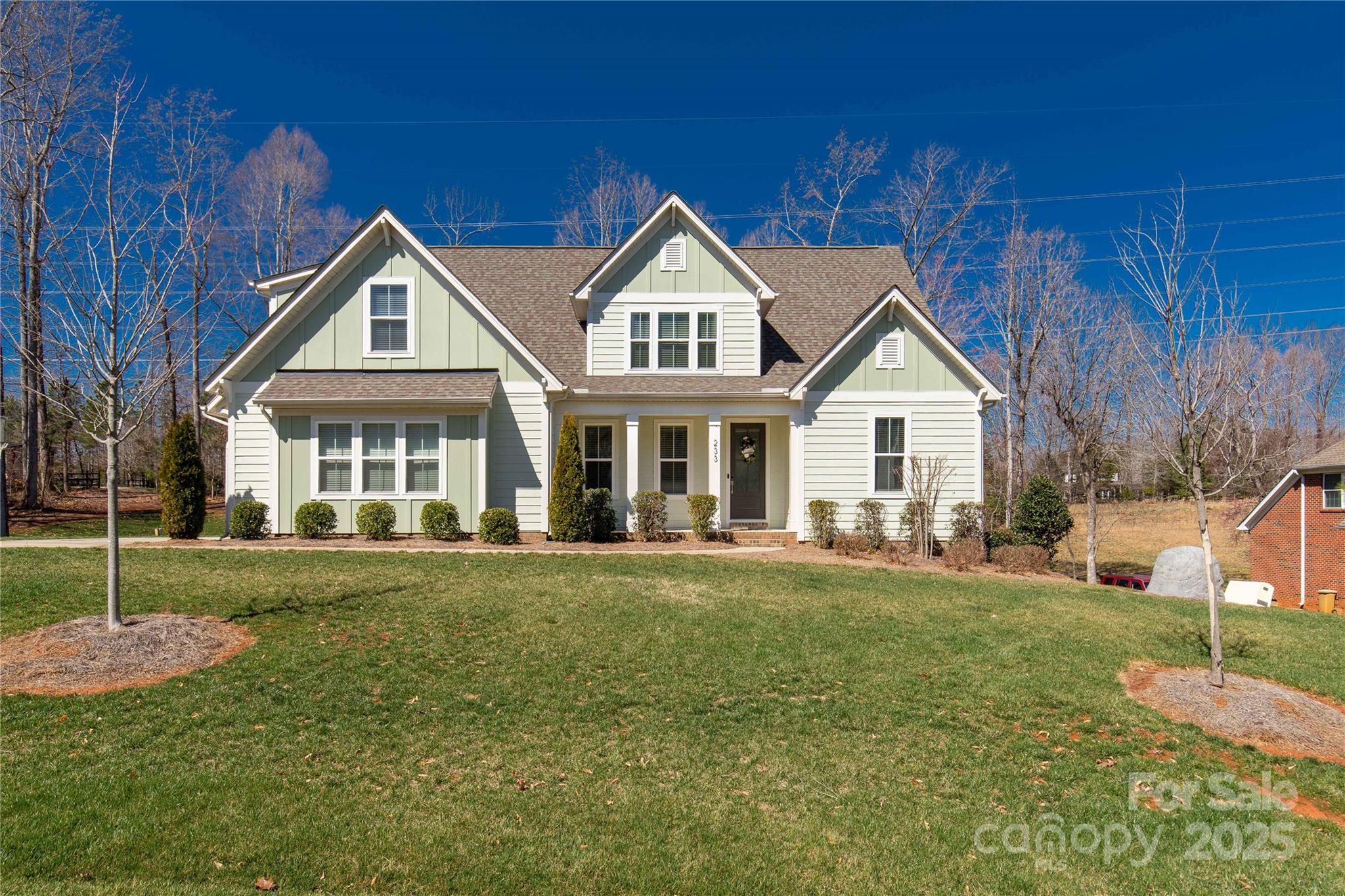 Welcome home! This semi custom home is built on a 1 acre lot in highly desirable Clover! The lot is the perfect blend of neighborhood and privacy. The modern floorplan offers owners suite on the first floor with a connecting laundry room and space for two home offices. The open design of the kitchen and family room offer the perfect space for entertaining. The kitchen features Bosch appliances, white perimeter cabinets, gray cabinets in the island, a farmhouse sink, herringbone backsplash, quartz counters, and a super convenient second pocket office. The family room has a fireplace and shiplap accent wall. Step out back to enjoy the privacy in the covered and screened in porch. The full first floor features hardwood laminate floors. On the second floor, each bedroom has its own bath and a large bonus room for play. Enjoy one of the most desirable neighborhoods sharing some of Lake Wylies most stunning views. Call for a showing and make this home today.