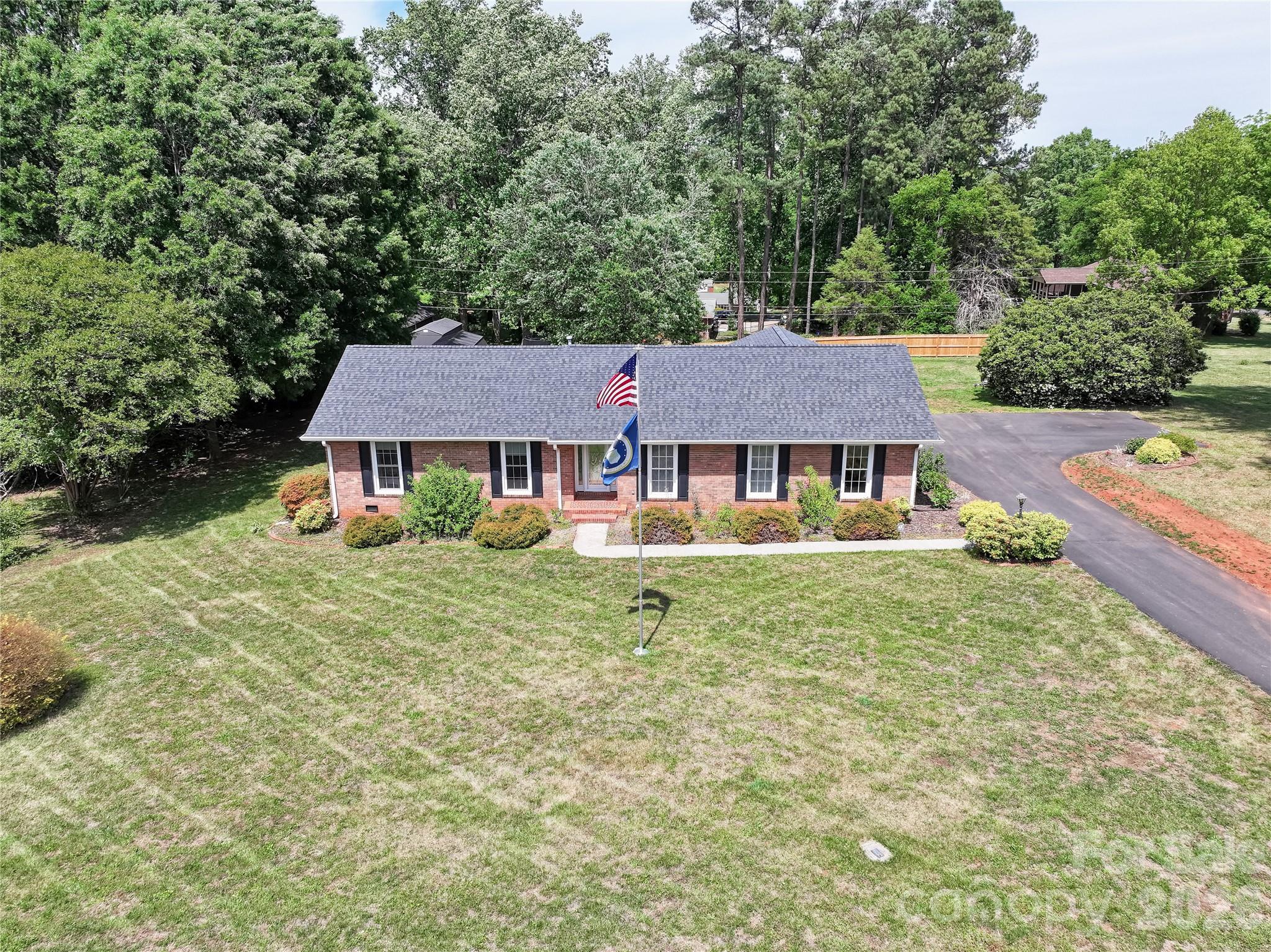 Move fast because homes with this much space, flexibility, and major recent upgrades do not last. Situated on approximately 3/4 of an acre in desirable Davie County, this ranch style home offers the layout and features buyers are desperately searching for. The main level features 3 spacious bedrooms and 2 full bathrooms with real hardwood floors throughout most of the upstairs, oversized living spaces filled with natural light, ceiling fans throughout, and a stunning owners suite complete with dual sinks and a floor to ceiling tiled walk in shower with dual shower heads. The oversized kitchen delivers abundant cabinet space, an in counter gas cooktop, wall oven, and kitchen refrigerator that conveys, making this home truly move in ready.
The fully finished walk out basement is where this property separates itself from the competition. With a large living area, kitchenette, washer and dryer hookups, full bathroom with tiled walk in shower, and flex space currently used as a fourth bedroom, the possibilities are endless. Whether you need an in law suite, private guest quarters, separate living space for family or home business setup, this basement gives buyers options that are hard to find at this price point.
Big ticket updates have already been completed for peace of mind including a brand new roof and gutters in 2024, two state of the art multi stage inverter heat pump systems with gas furnaces, new dishwasher in 2025, widened driveway with additional parking area, and a brand new storage shed featuring swing doors, porch, roll up door, and ramps perfect for equipment, motorcycles, or workshop storage. Enjoy cozy evenings by the working gas fireplace upstairs, privacy fencing along the rear property line, attic storage access, and a convenient carport with second entrance for easy access.
Located close to shopping, the Davie Community Center, and offering an easy commute to Statesville, Salisbury, Winston Salem, and Charlotte, this home delivers the perfect combination of convenience, functionality, and long term value. Opportunities like this are rare and buyers looking for space, flexibility, and upgrades will immediately recognize the value here. Schedule your showing today and bring your offer before someone else beats you to it.