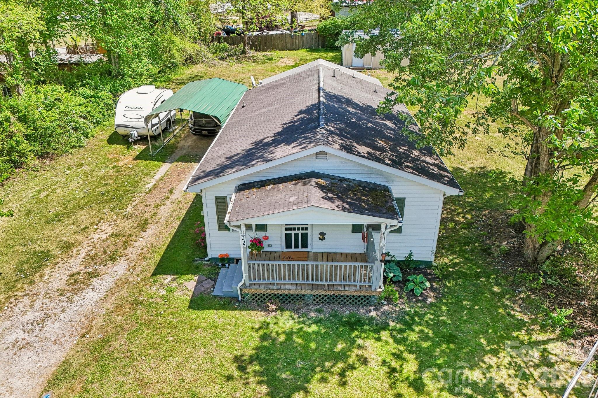 Charming and move-in ready, this cozy cottage is conveniently located just 10 minutes from downtown Hendersonville and only 3 minutes from I-26 and all that WNC has to offer! Perfect for first-time buyers, downsizers, or investors, this thoughtfully updated home offers comfort, convenience, and value.

This home features beautiful hardwood floors, abundant natural light, a spacious kitchen with breakfast bar, and a covered back deck to sit and relax. The two bedrooms feature new LVP flooring, including one with an oversized built-in closet. Recent updates include a new energy-efficient mini-split system and a 50-gallon Bradford White Hydrojet water heater. 

A large workshop in the back provides endless possibilities for hobbies, storage, studio space, or even the opportunity to convert it into a tiny home! An additional shed and carport add even more functionality to this ready-to-call-home cozy cottage. All of this on a .26-acre lot in a convenient location close to shopping, dining, and everything Henderson County has to offer.